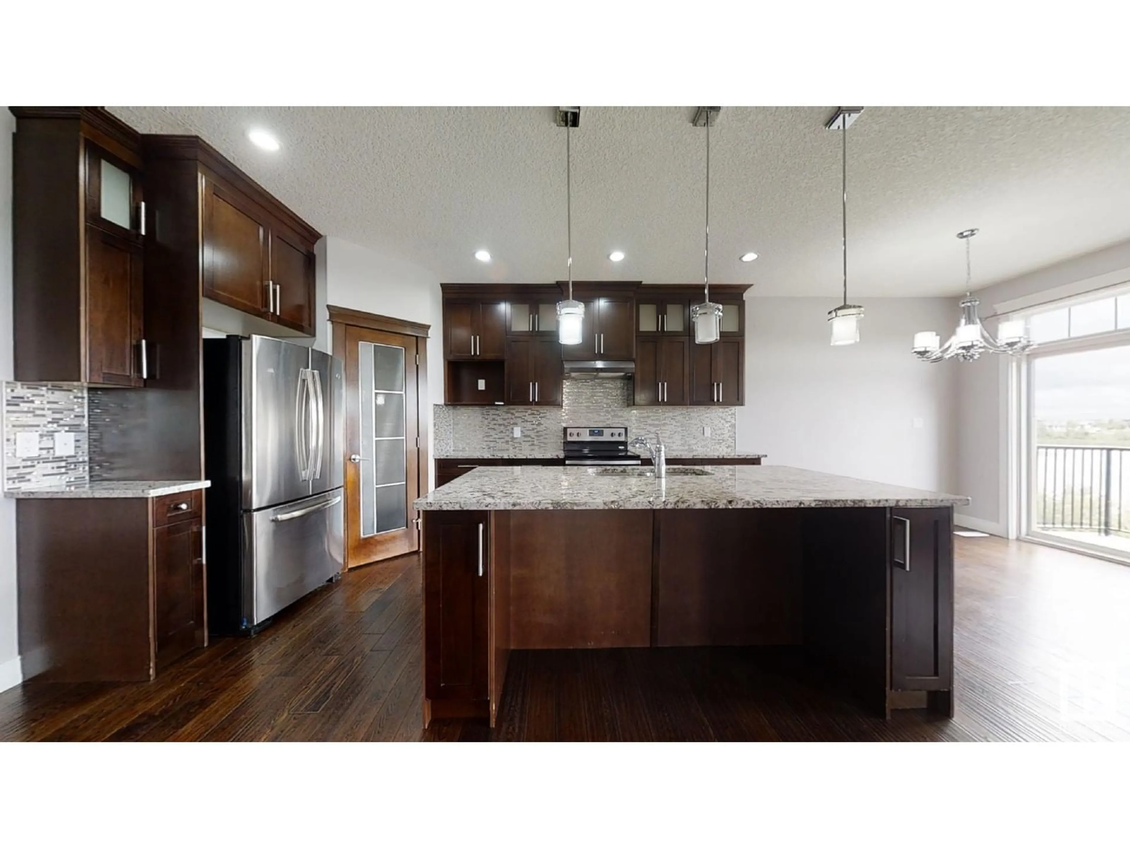 Open concept kitchen, wood/laminate floor for 75 SELKIRK PL, Leduc Alberta T9E0L5