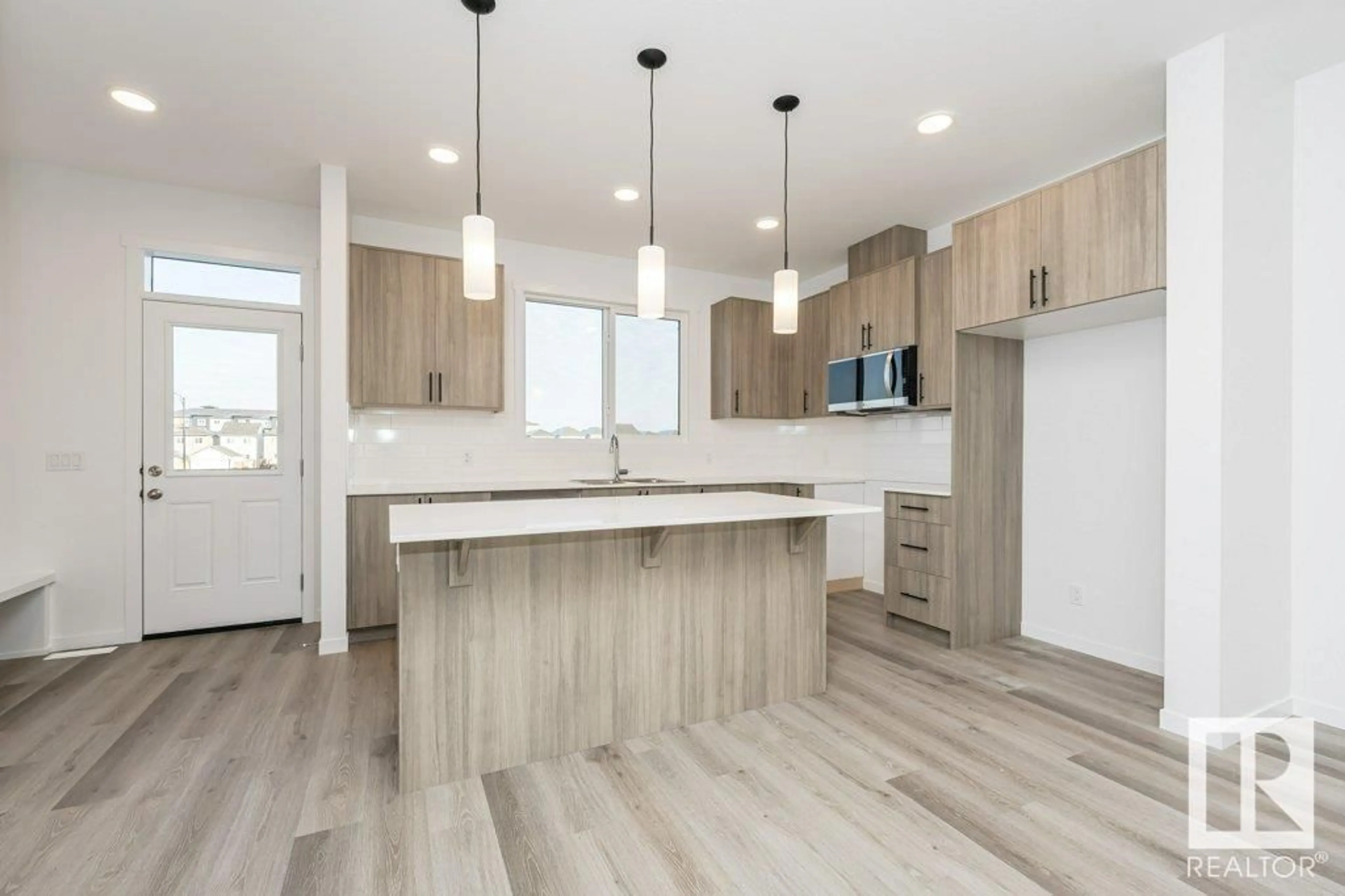 Open concept kitchen, wood/laminate floor for 6244 175 AV NW, Edmonton Alberta T5Y4H3