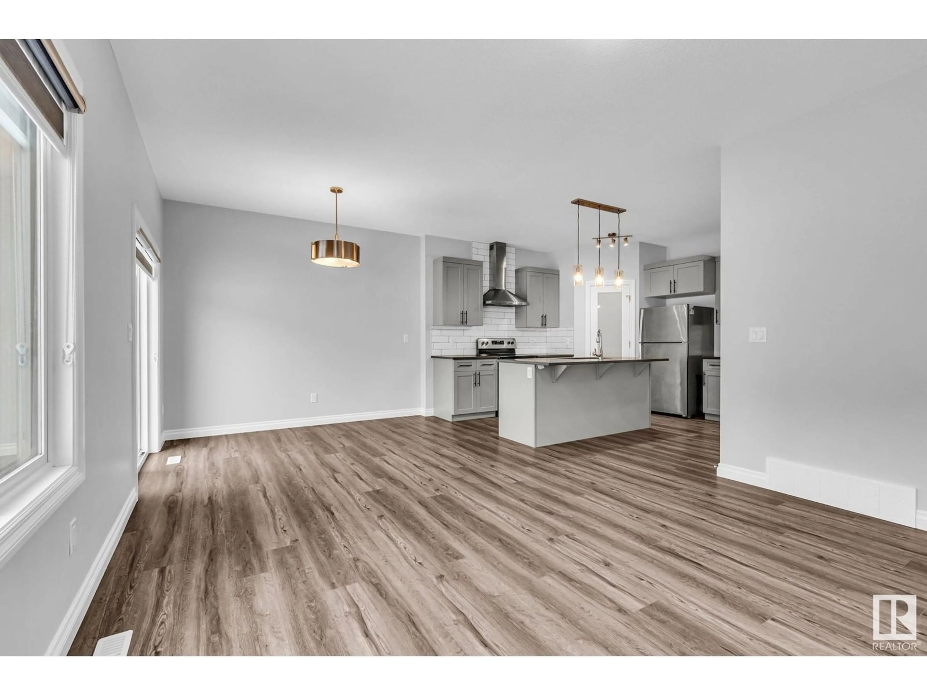 Open concept kitchen, wood/laminate floor for 9232 pear DR SW SW, Edmonton Alberta T6X2X5