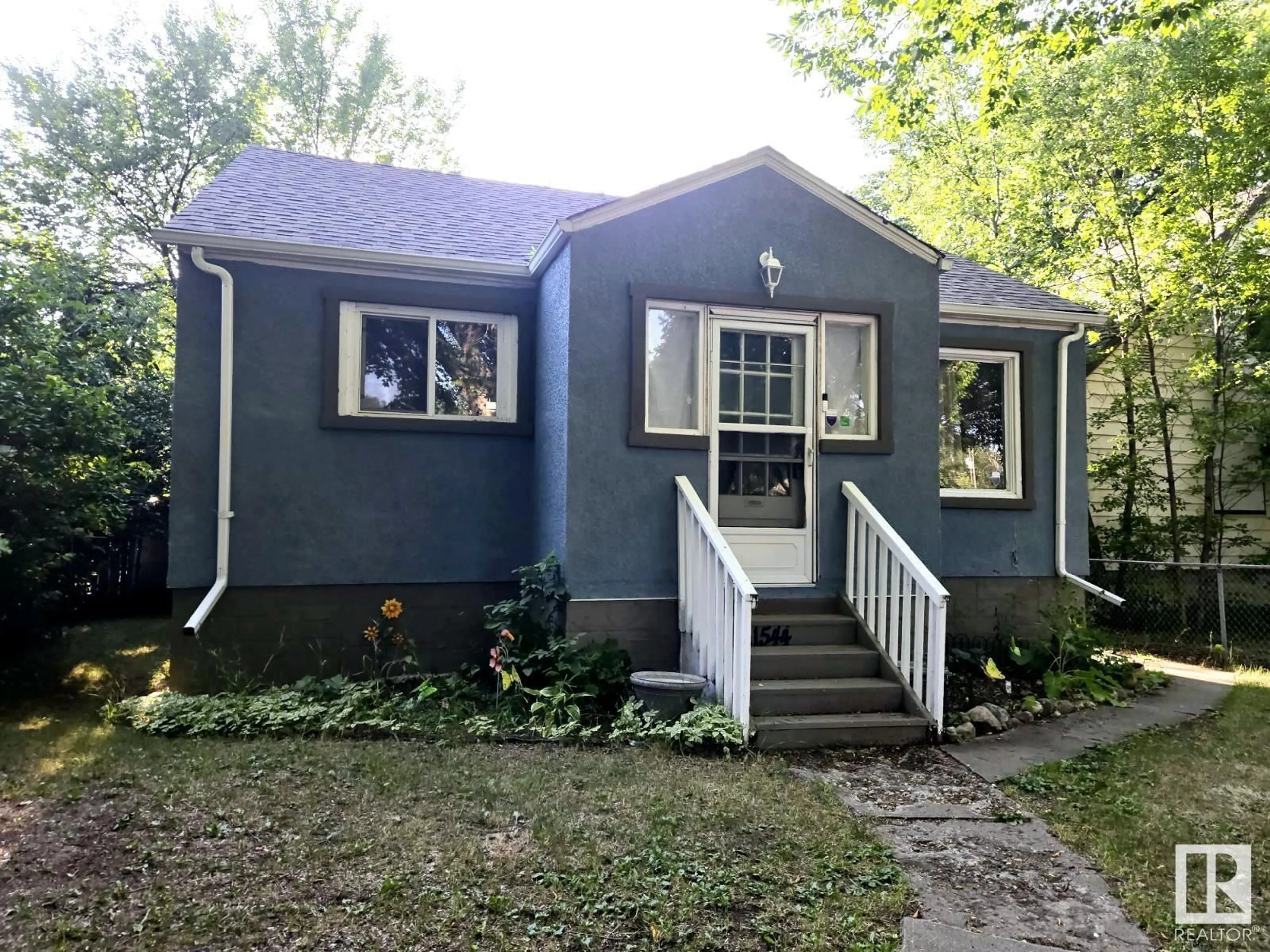 Home with vinyl exterior material, street for 11544 88 ST NW NW, Edmonton Alberta T5R3B3