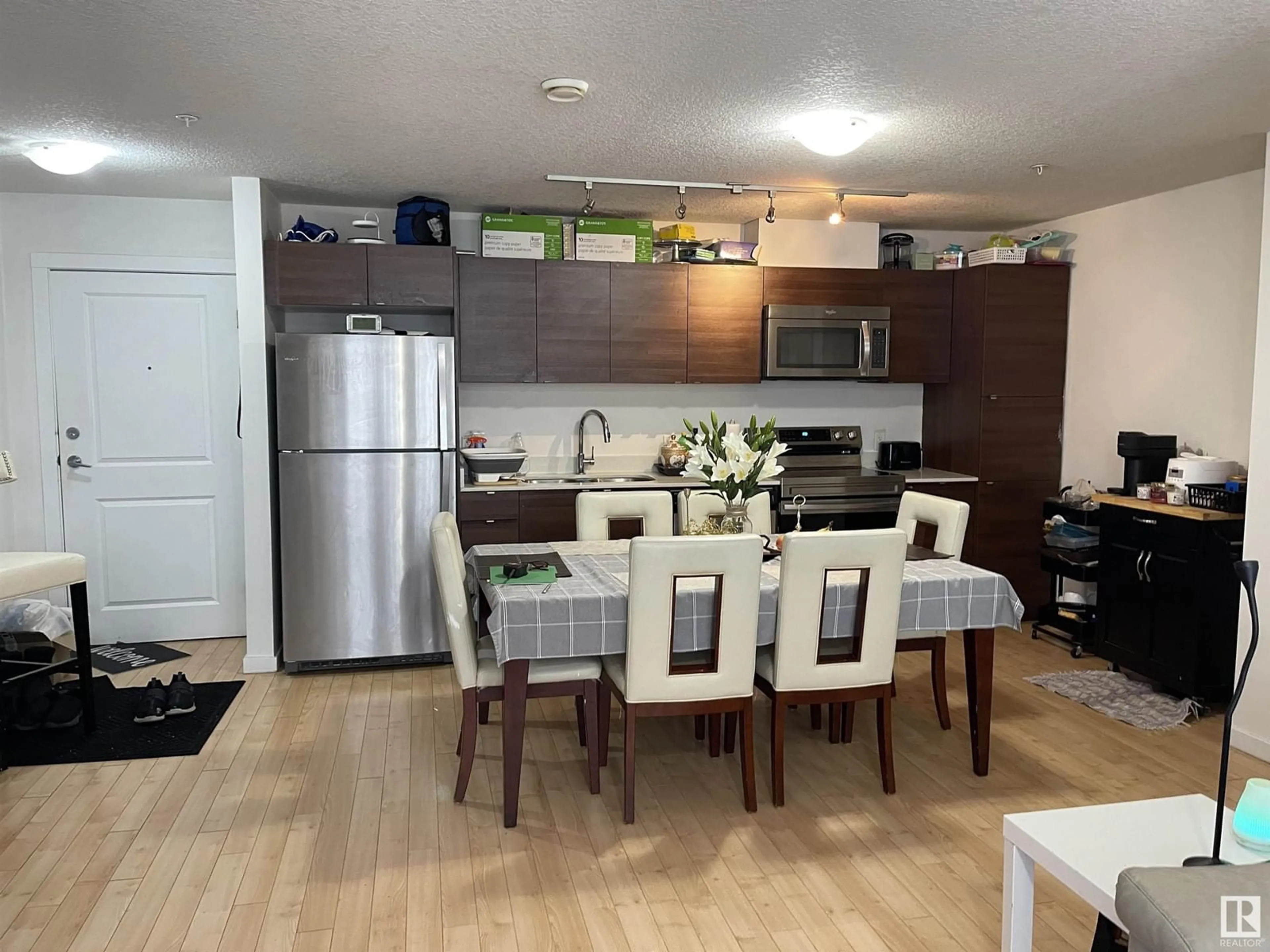 Open concept kitchen, wood/laminate floor for #112 9519 160 AV NW NW, Edmonton Alberta T5Z0N1