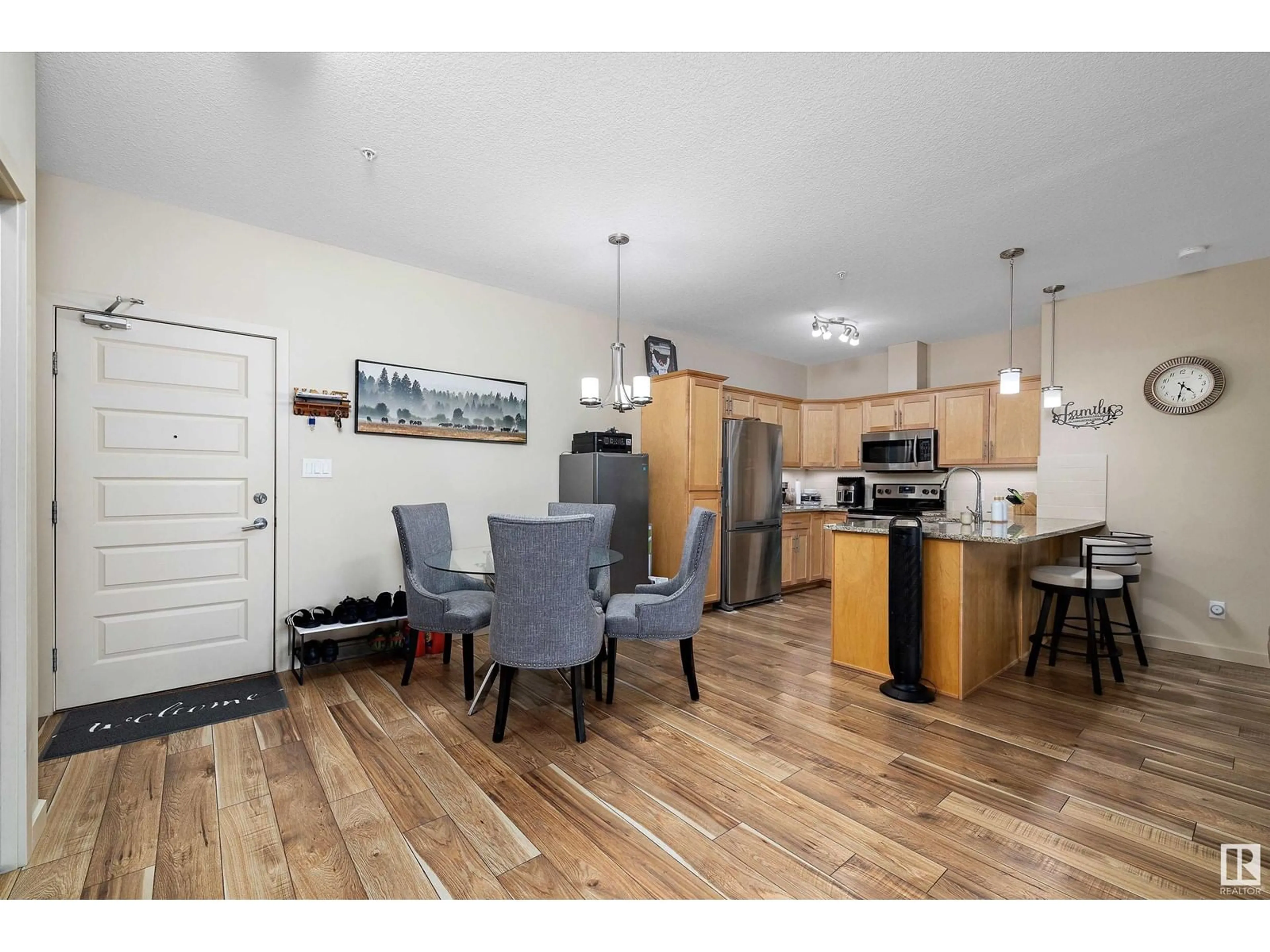 Open concept kitchen, wood/laminate floor for #214 304 Ambleside Li SW, Edmonton Alberta T6W0V2