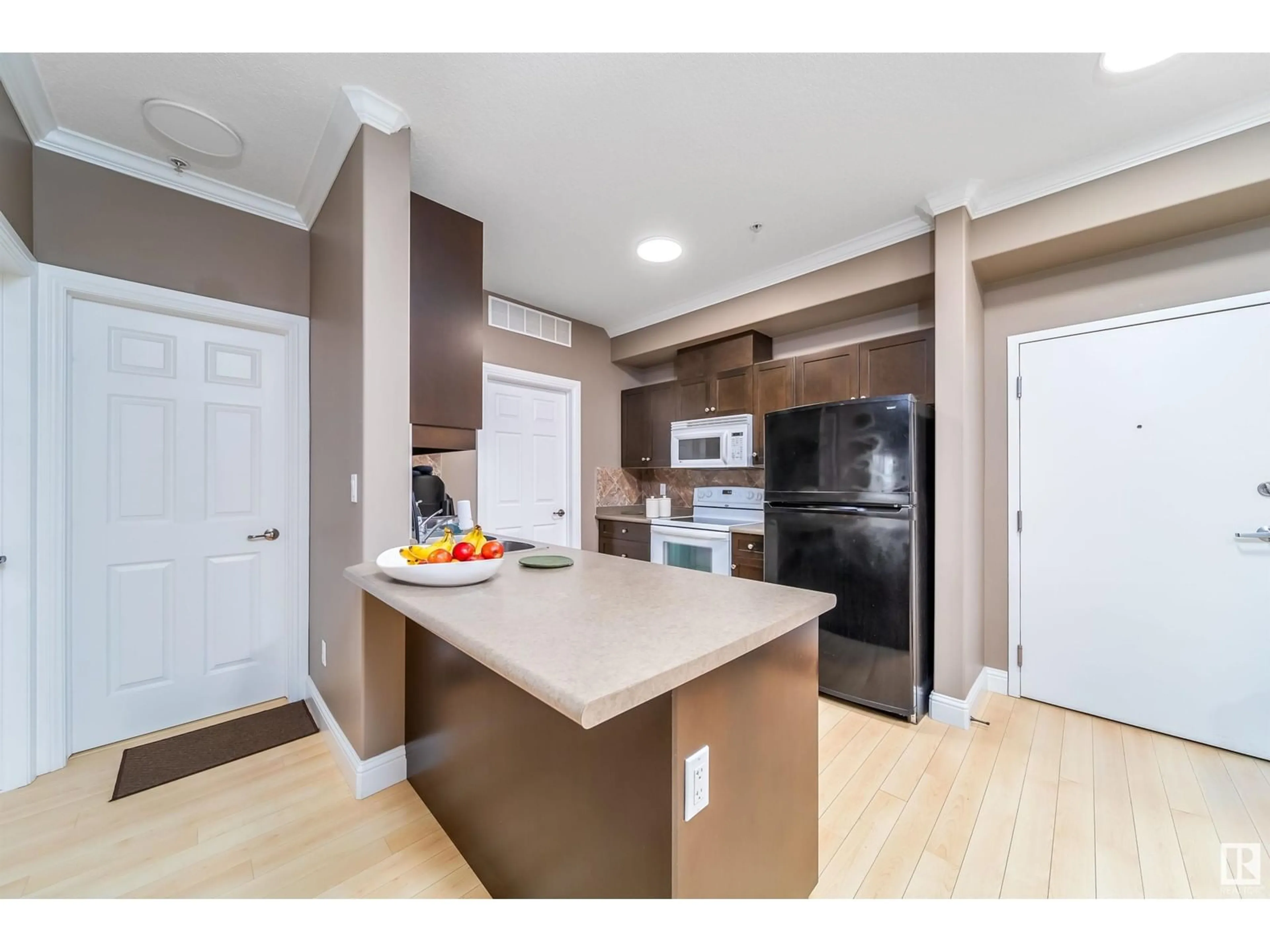 Open concept kitchen, wood/laminate floor for #102 14612 125 ST NW NW, Edmonton Alberta T5X0B6