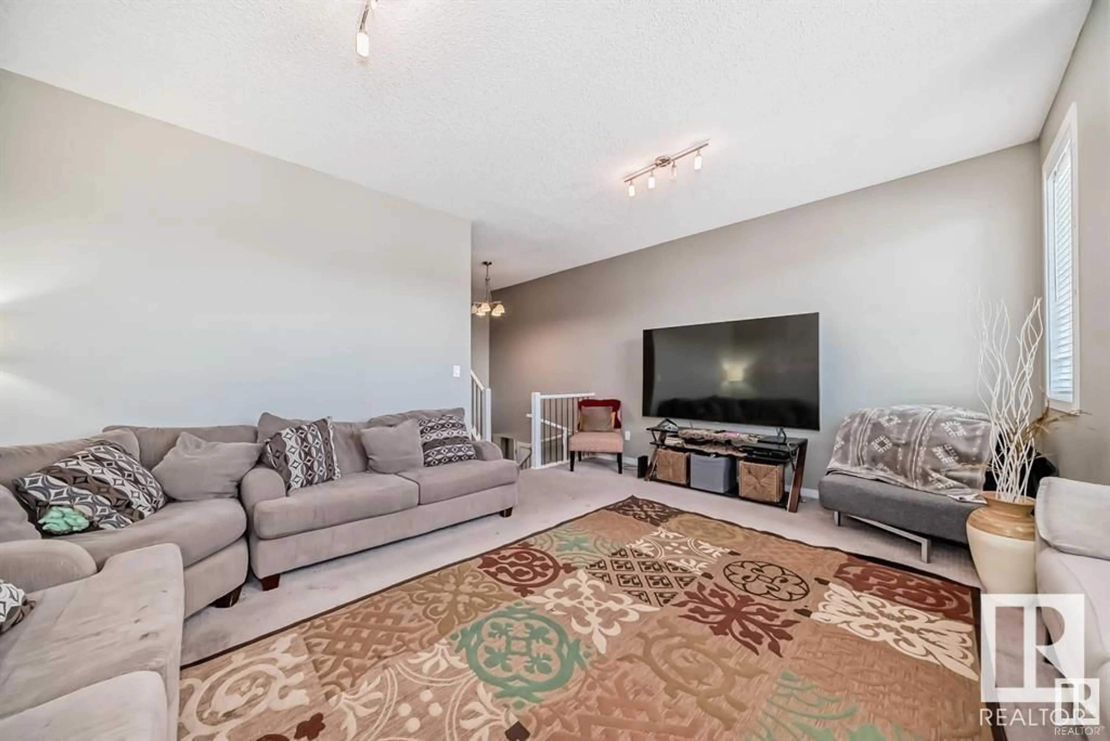 Living room with furniture, carpet floor for 13827 143 AV NW, Edmonton Alberta T6V0L7