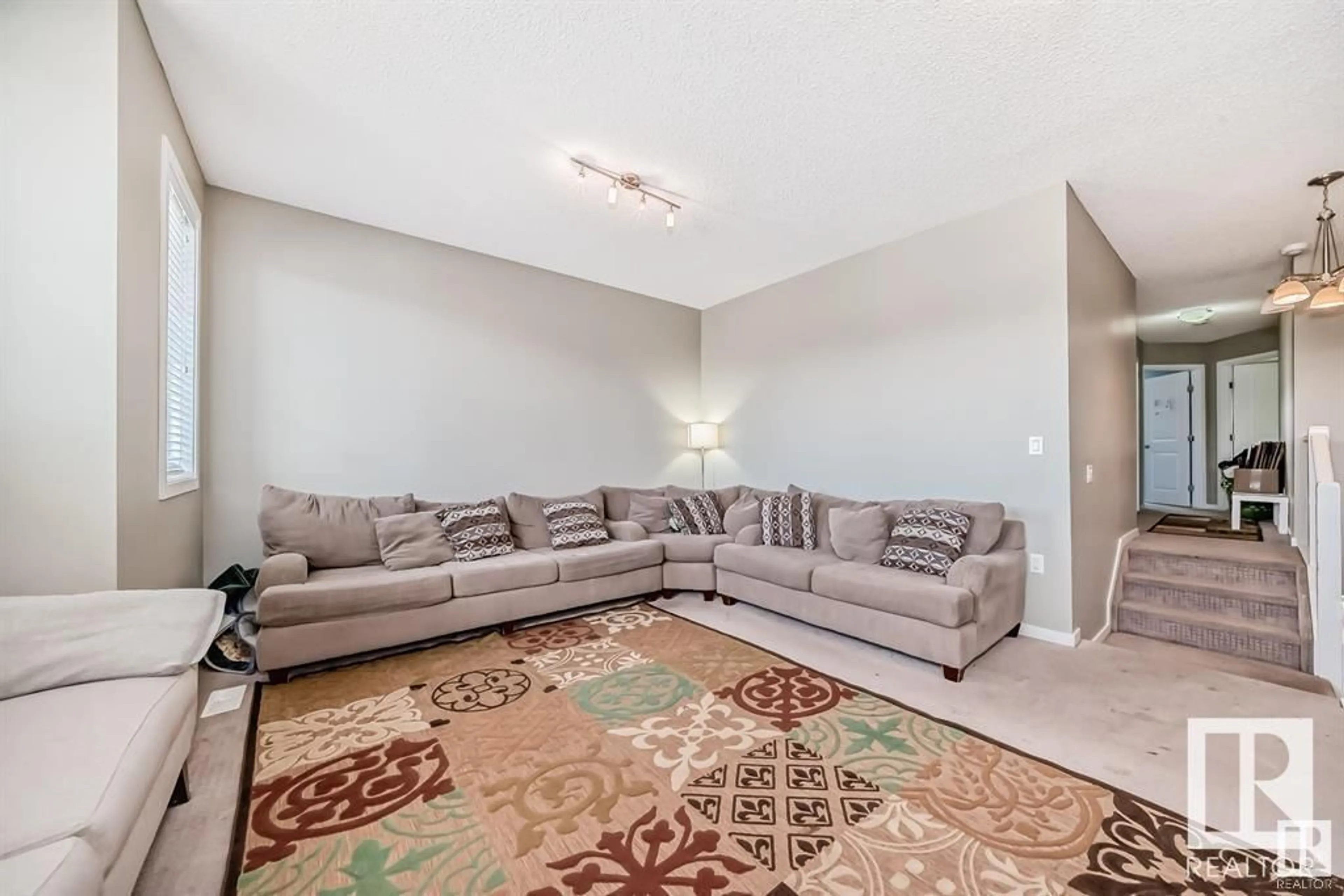 Living room with furniture, carpet floor for 13827 143 AV NW, Edmonton Alberta T6V0L7