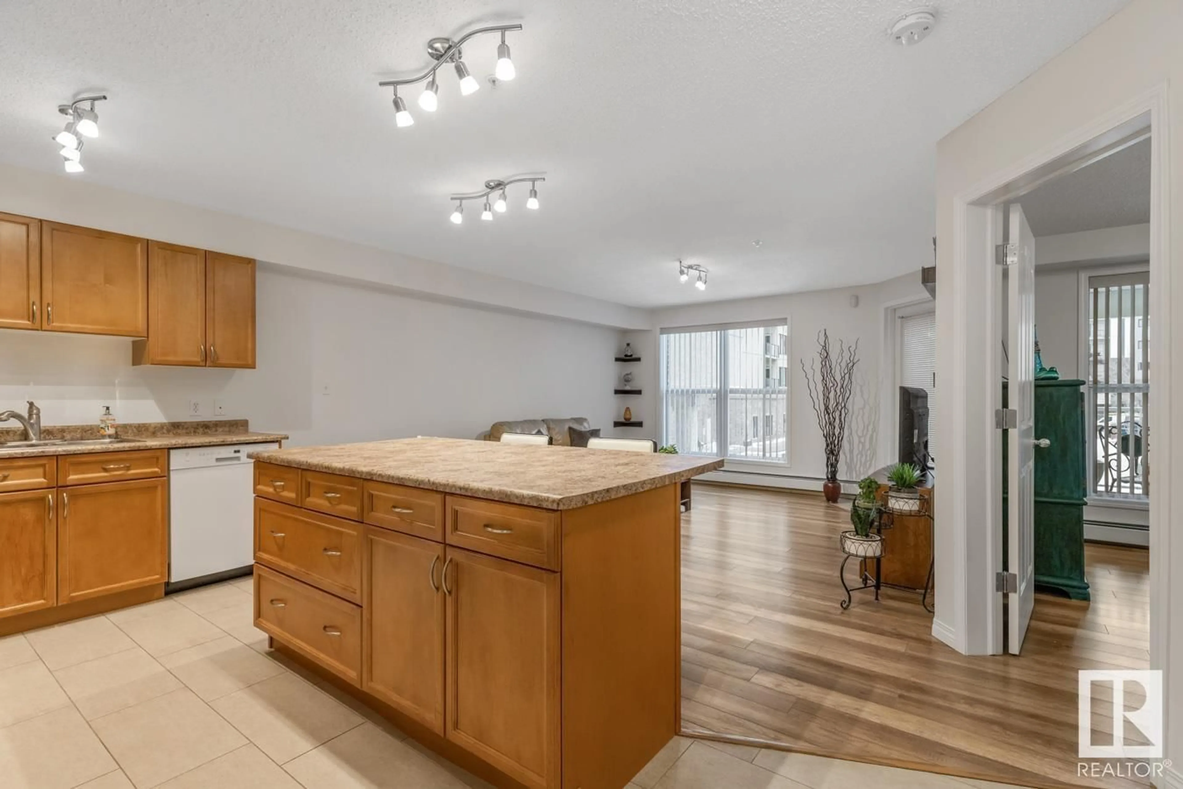 Open concept kitchen, wood/laminate floor for #217 10311 111 ST NW, Edmonton Alberta T5K2Y8