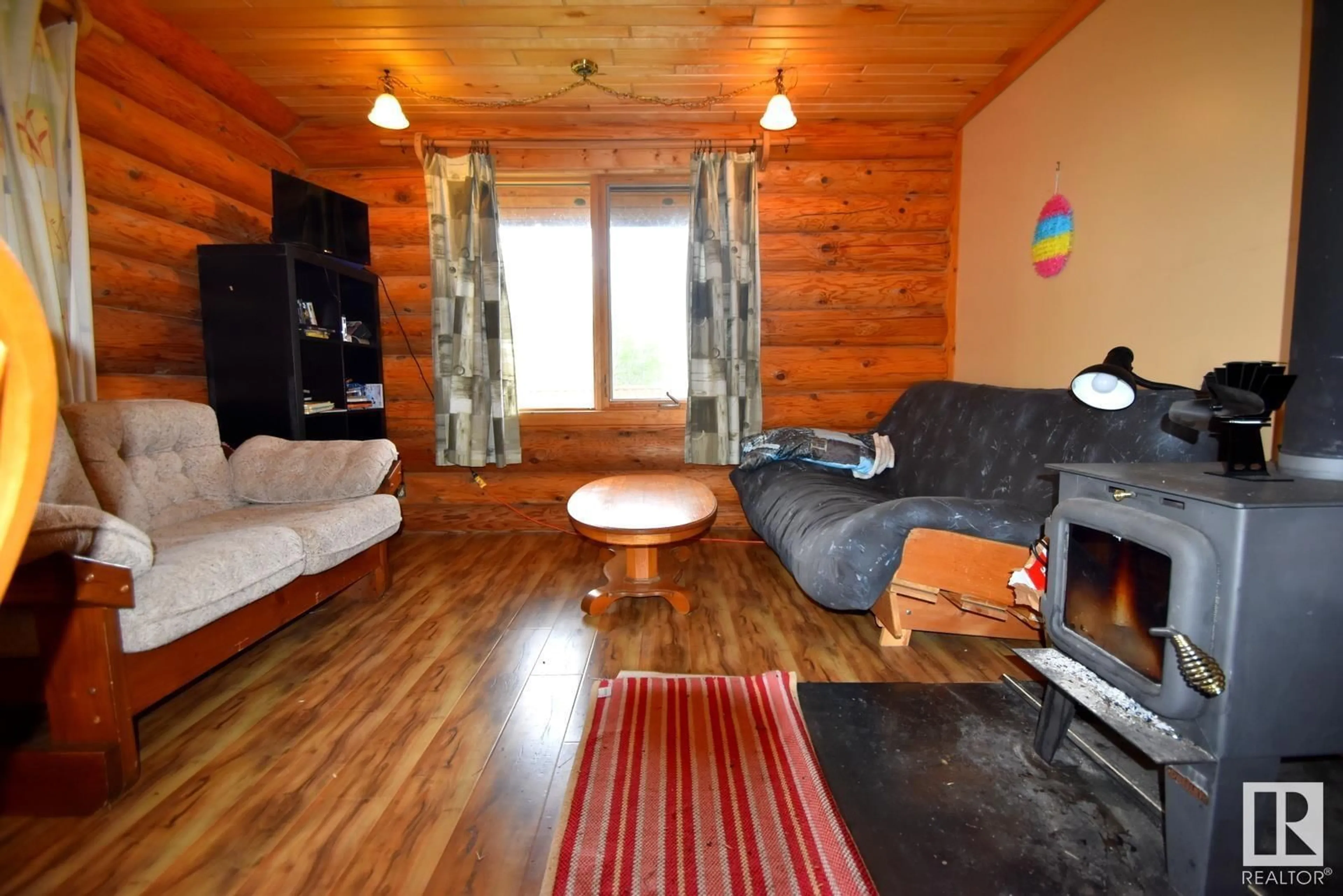 Living room with furniture, wood/laminate floor for 9 Tee Pee Dr TEE PEE LAKE EST, Rural Athabasca County Alberta T0A0M0