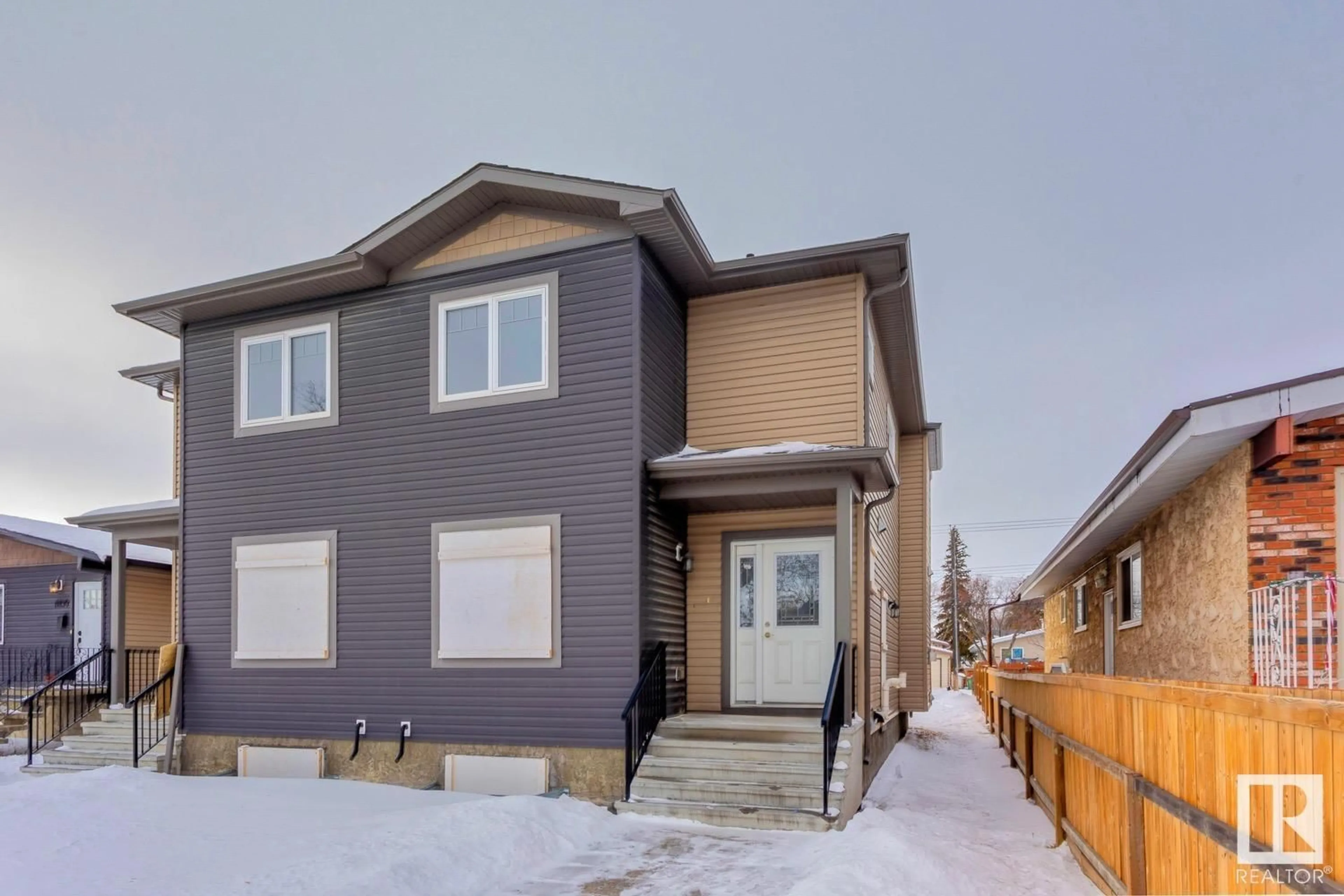 Home with vinyl exterior material, street for 11832 & 11834 124 ST NW, Edmonton Alberta T5L0M4