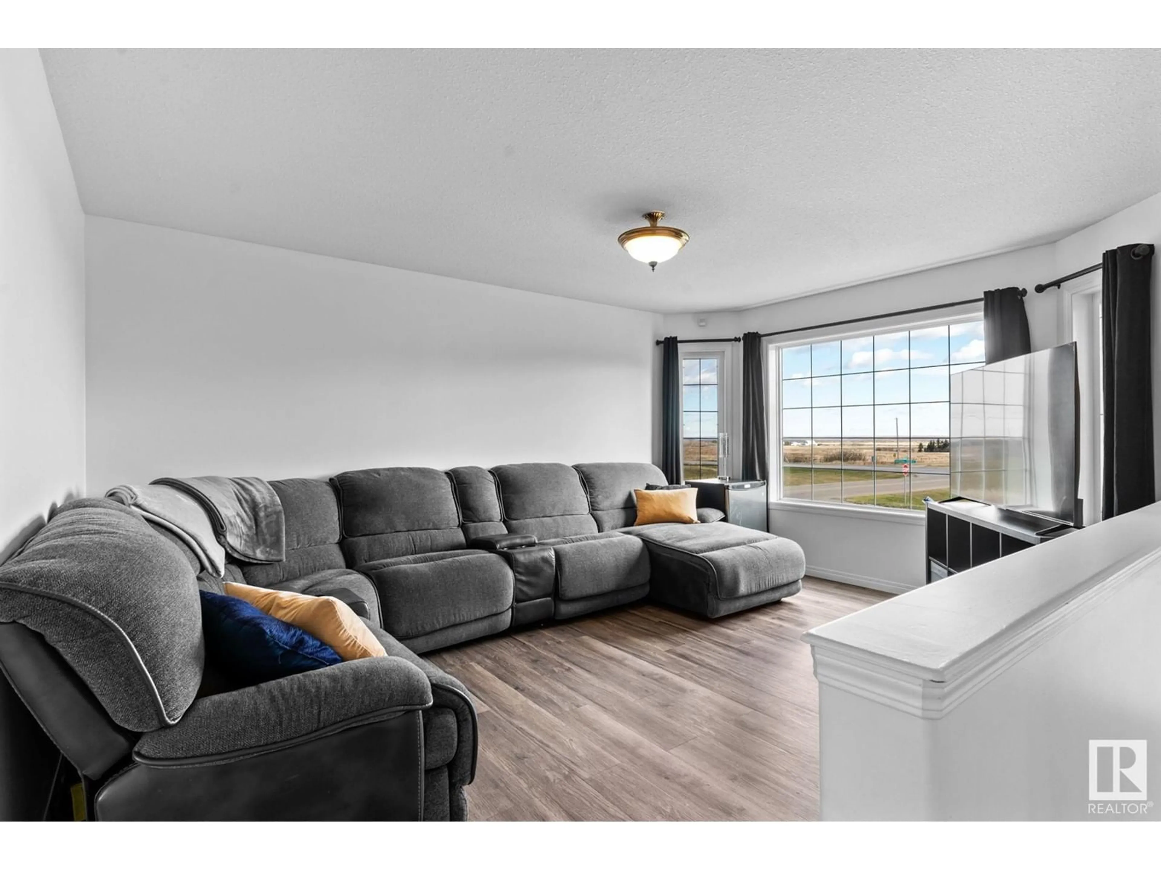 Living room with furniture, wood/laminate floor for 2 BEAVERHILL CR, Tofield Alberta T0B4J0