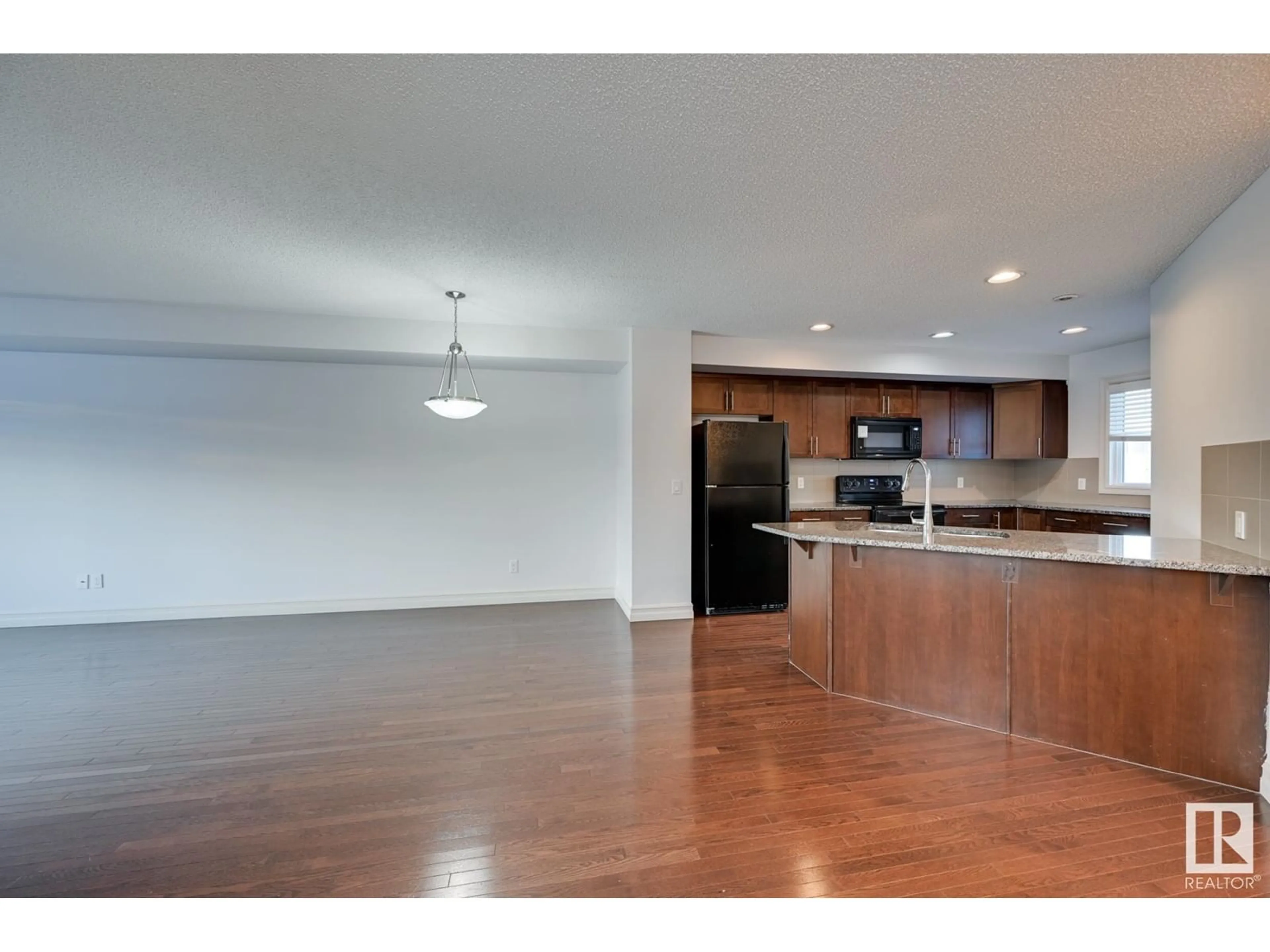 Open concept kitchen, wood/laminate floor for #141 2336 ASPEN TR, Sherwood Park Alberta T8H0J1