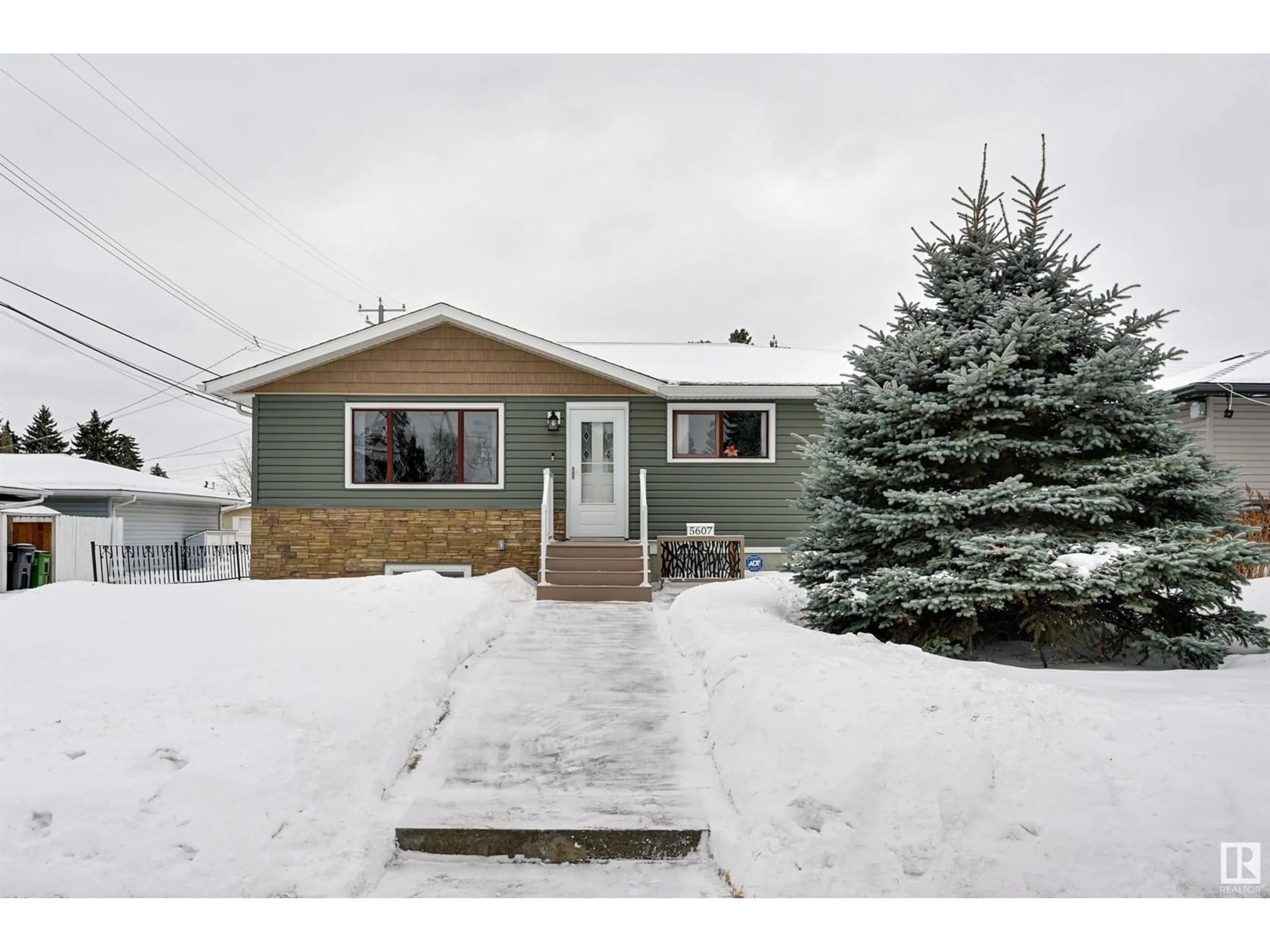 Home with vinyl exterior material, street for 5607 85 AV NW NW, Edmonton Alberta T6B0J1