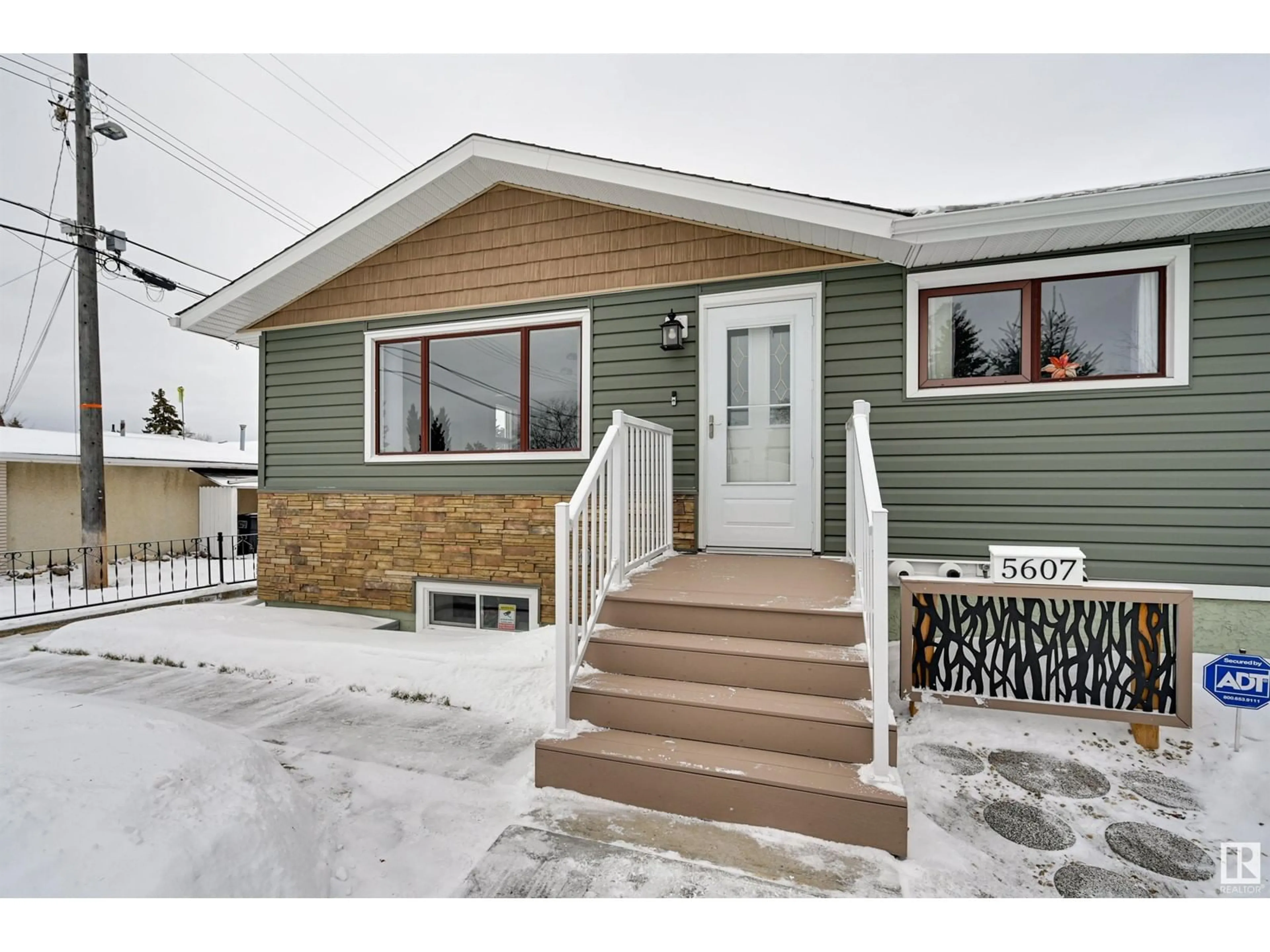 Home with vinyl exterior material, street for 5607 85 AV NW NW, Edmonton Alberta T6B0J1