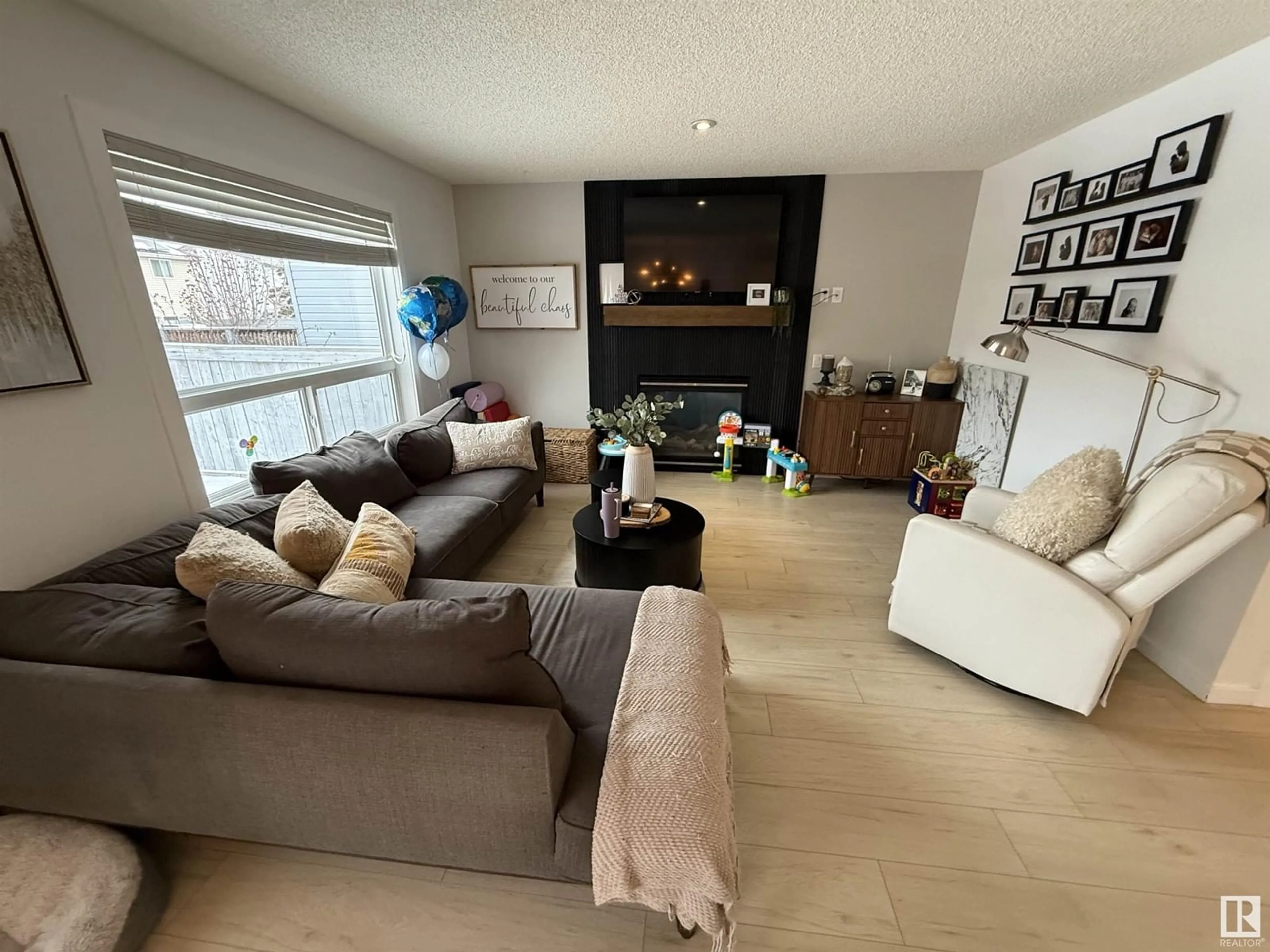 Living room with furniture, wood/laminate floor for 19040 47 AV NW, Edmonton Alberta T6M2V6