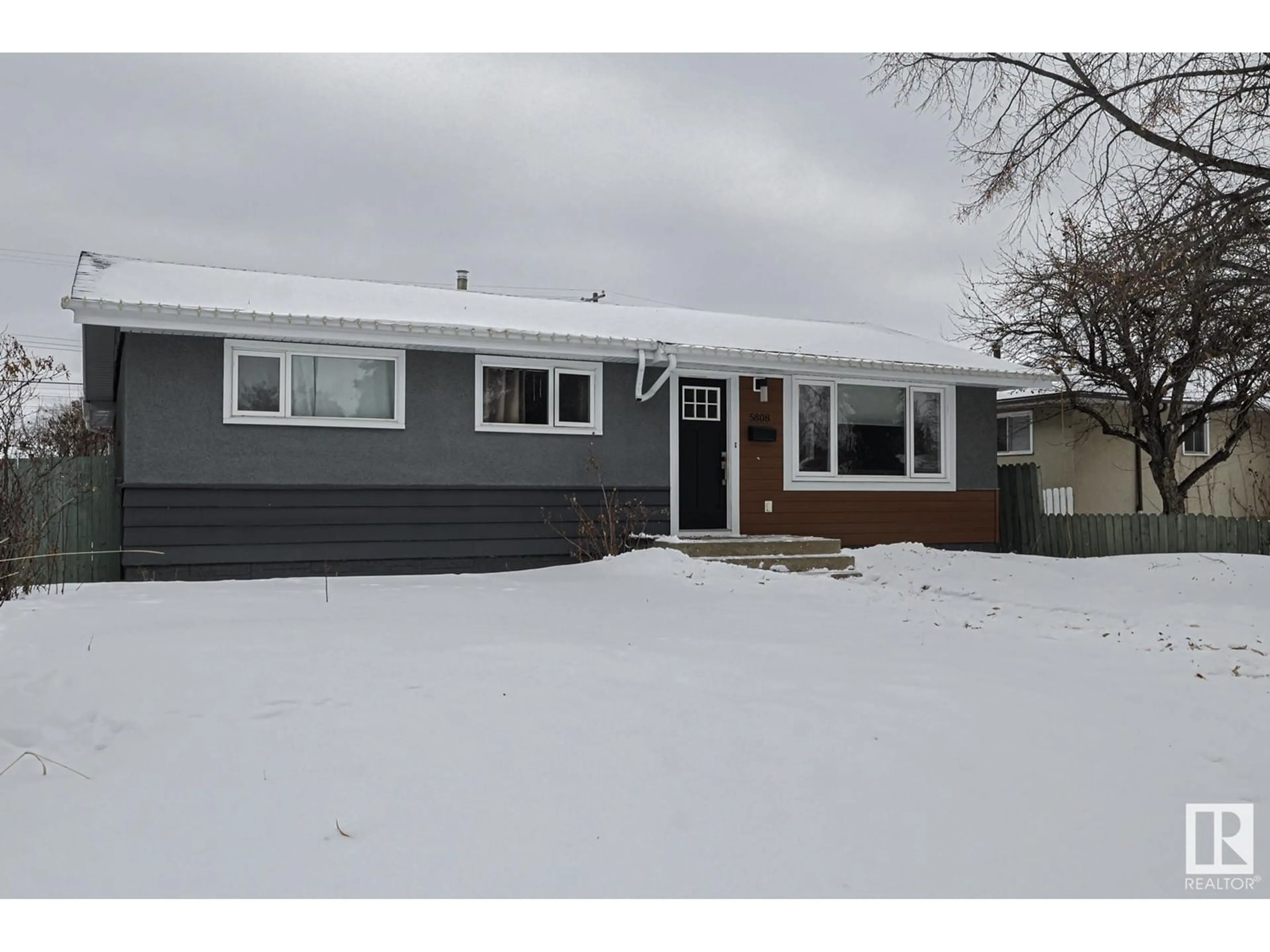 Home with vinyl exterior material, street for 5808 94A AV NW NW, Edmonton Alberta T6B0Y8