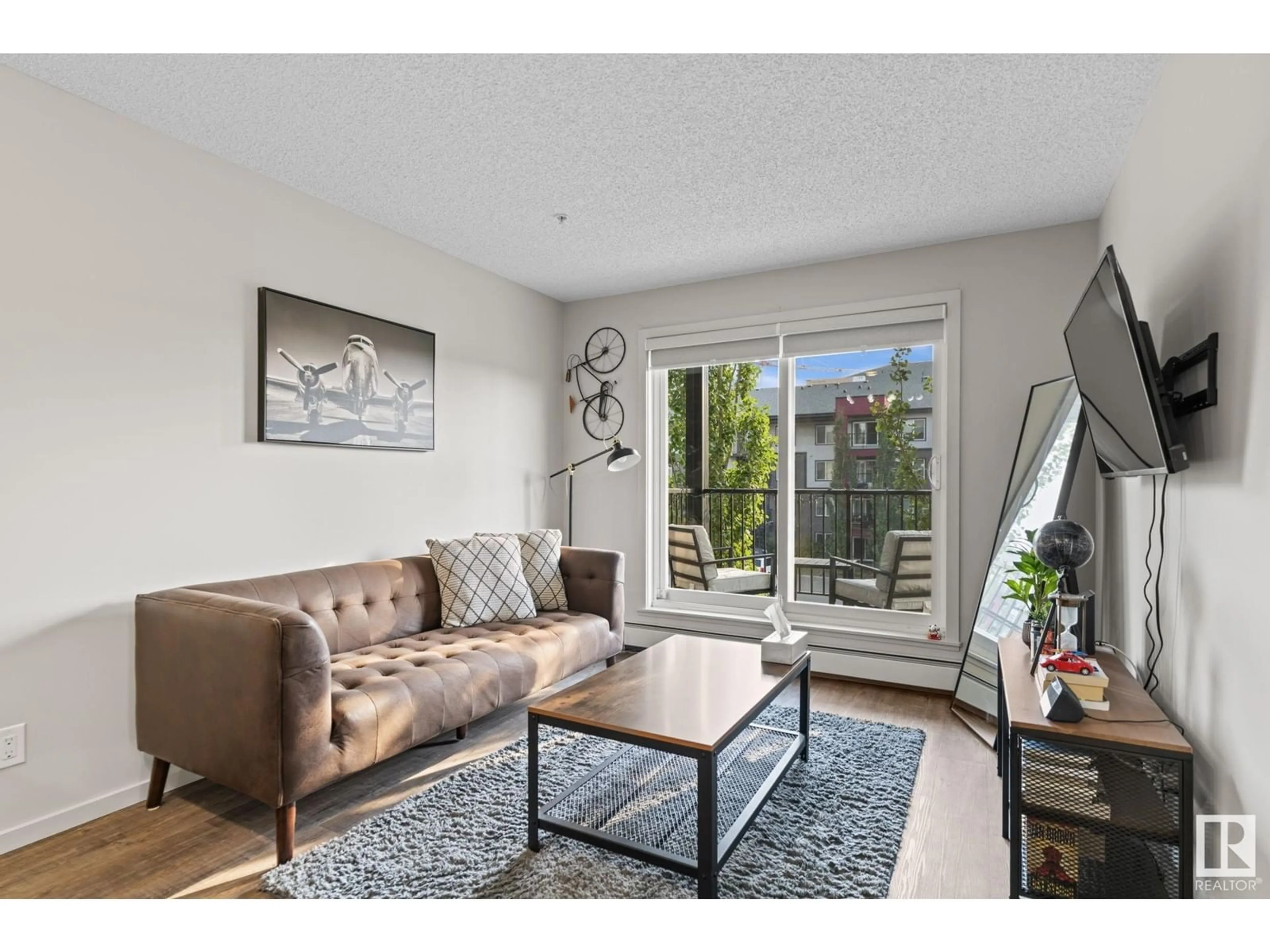 Living room with furniture, wood/laminate floor for #303 5521 7 AV SW, Edmonton Alberta T6X2A8