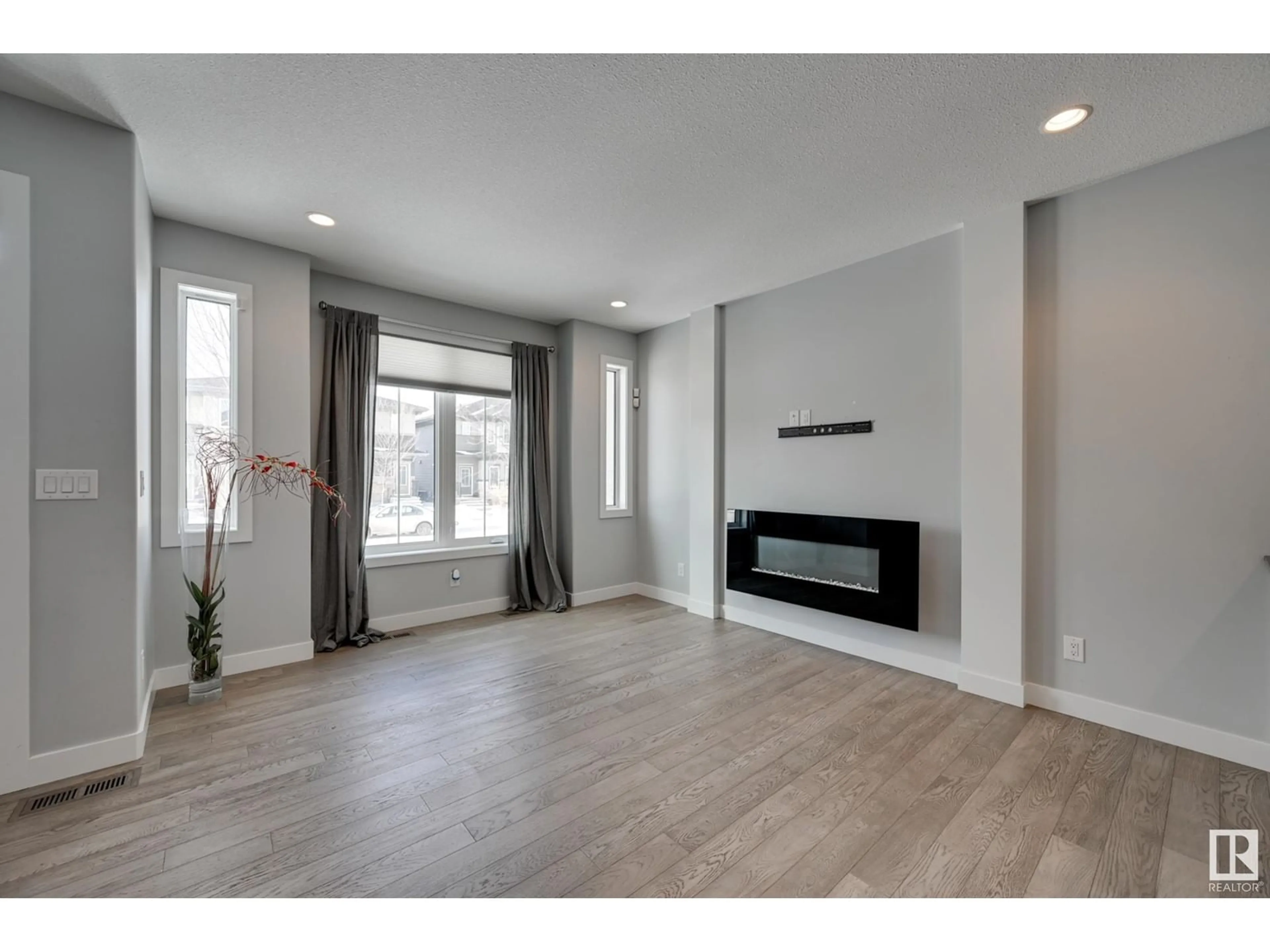 Living room with furniture, wood/laminate floor for 3137 KESWICK WY SW, Edmonton Alberta T6W0S5