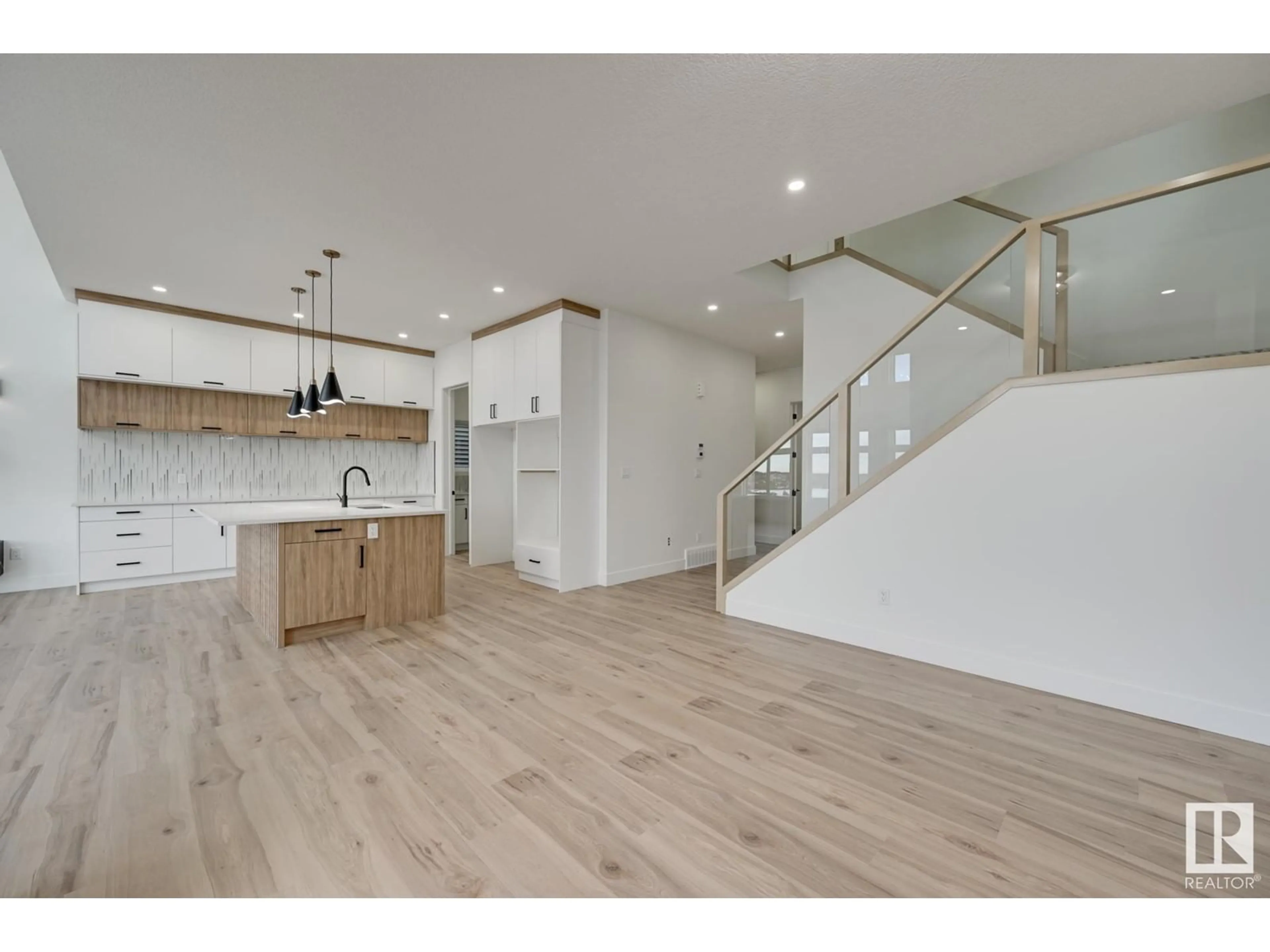 Open concept kitchen, wood/laminate floor for 7099 KIVIAQ CR SW, Edmonton Alberta T6W5N7