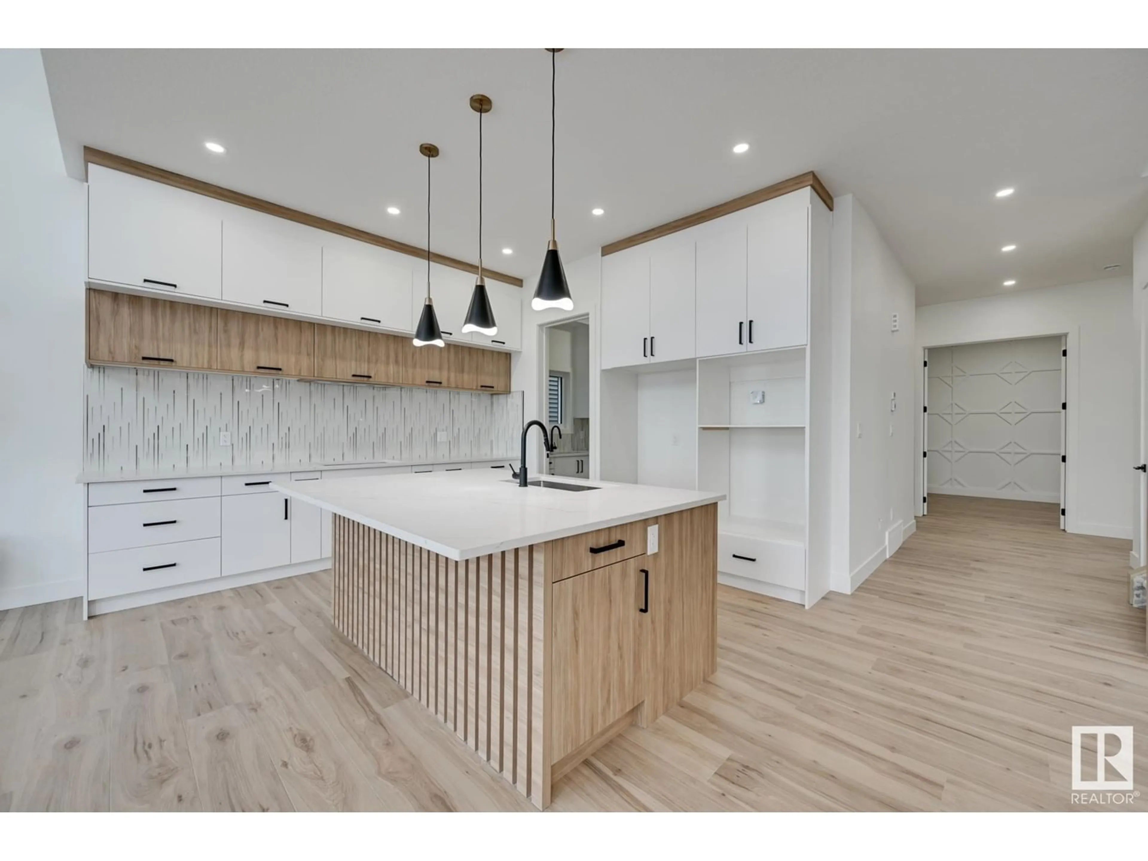 Open concept kitchen, wood/laminate floor for 7099 KIVIAQ CR SW, Edmonton Alberta T6W5N7