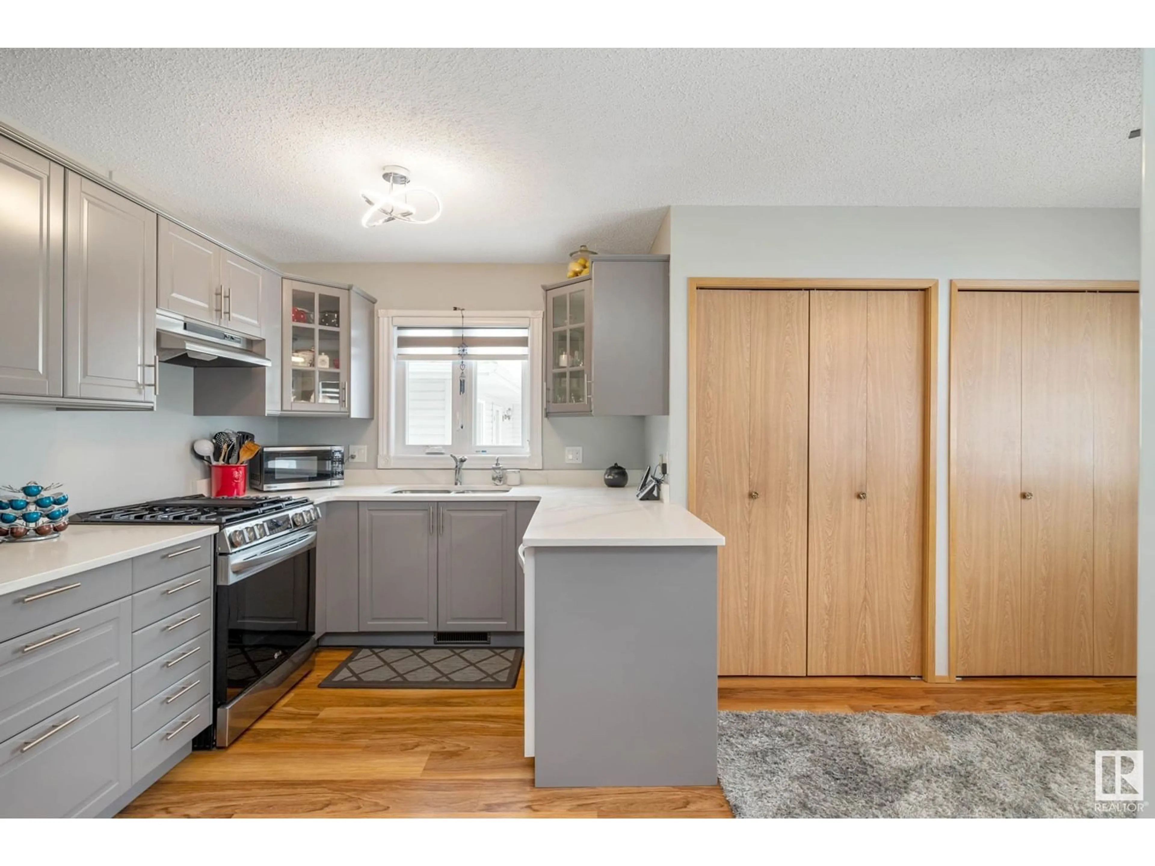 Open concept kitchen, wood/laminate floor for #22 903 109 ST NW NW, Edmonton Alberta T6J6R1