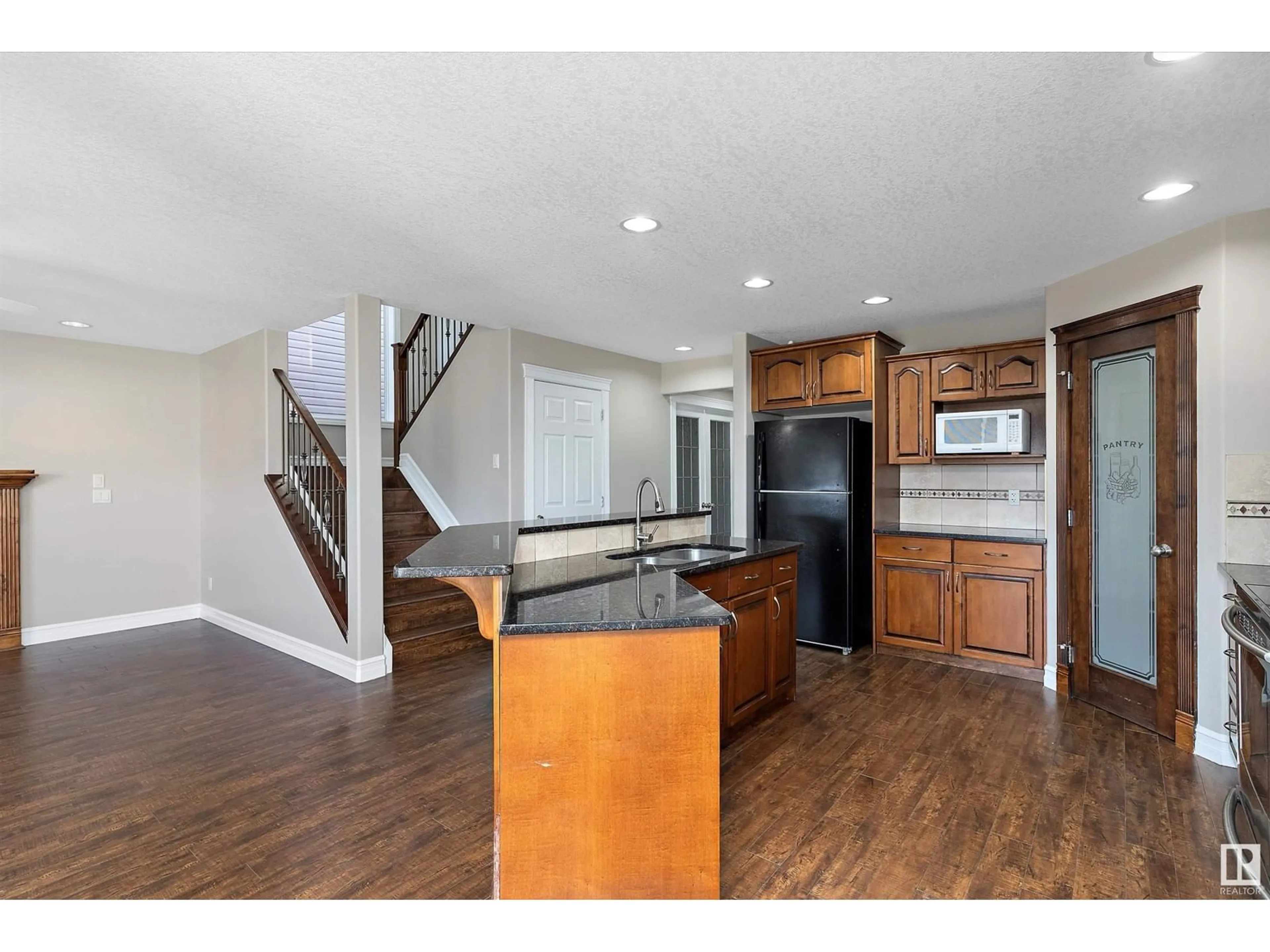 Open concept kitchen, wood/laminate floor for 16413 45 ST NW, Edmonton Alberta T5Y0A8