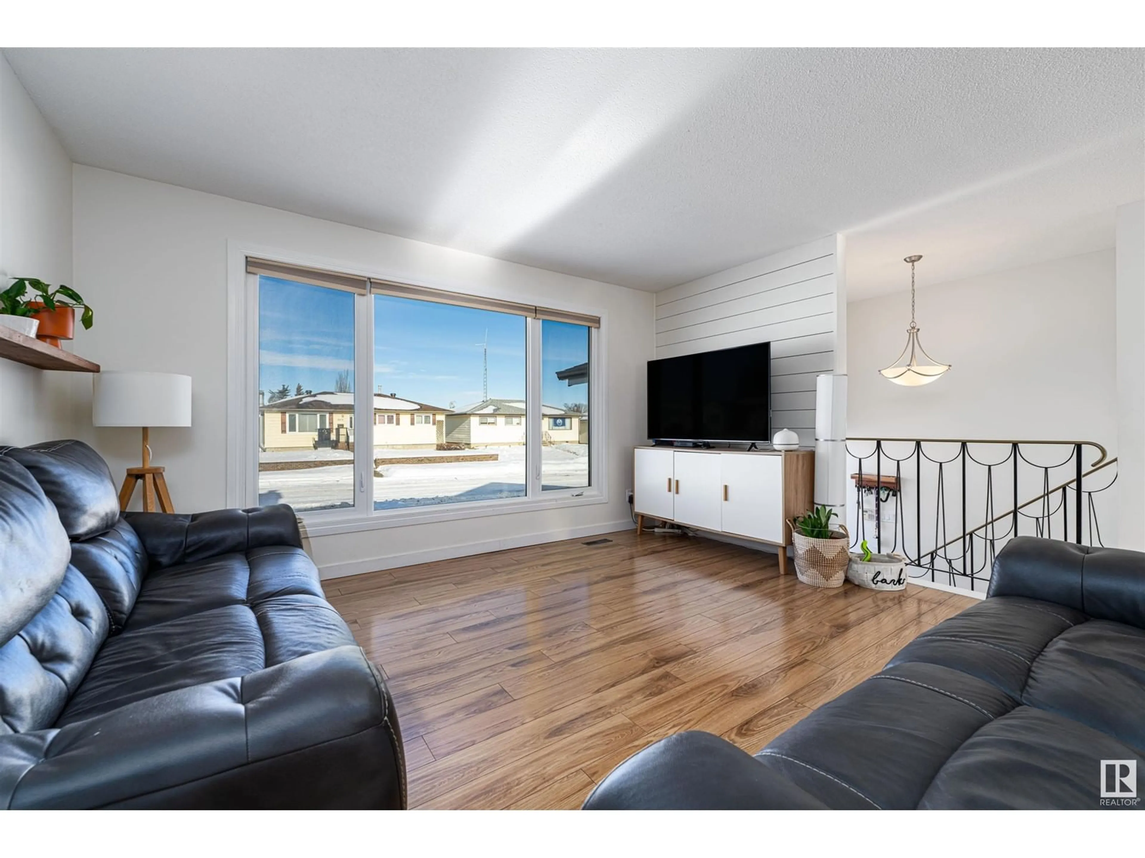 Living room with furniture, wood/laminate floor for 8411 148 AV NW, Edmonton Alberta T5E2K9