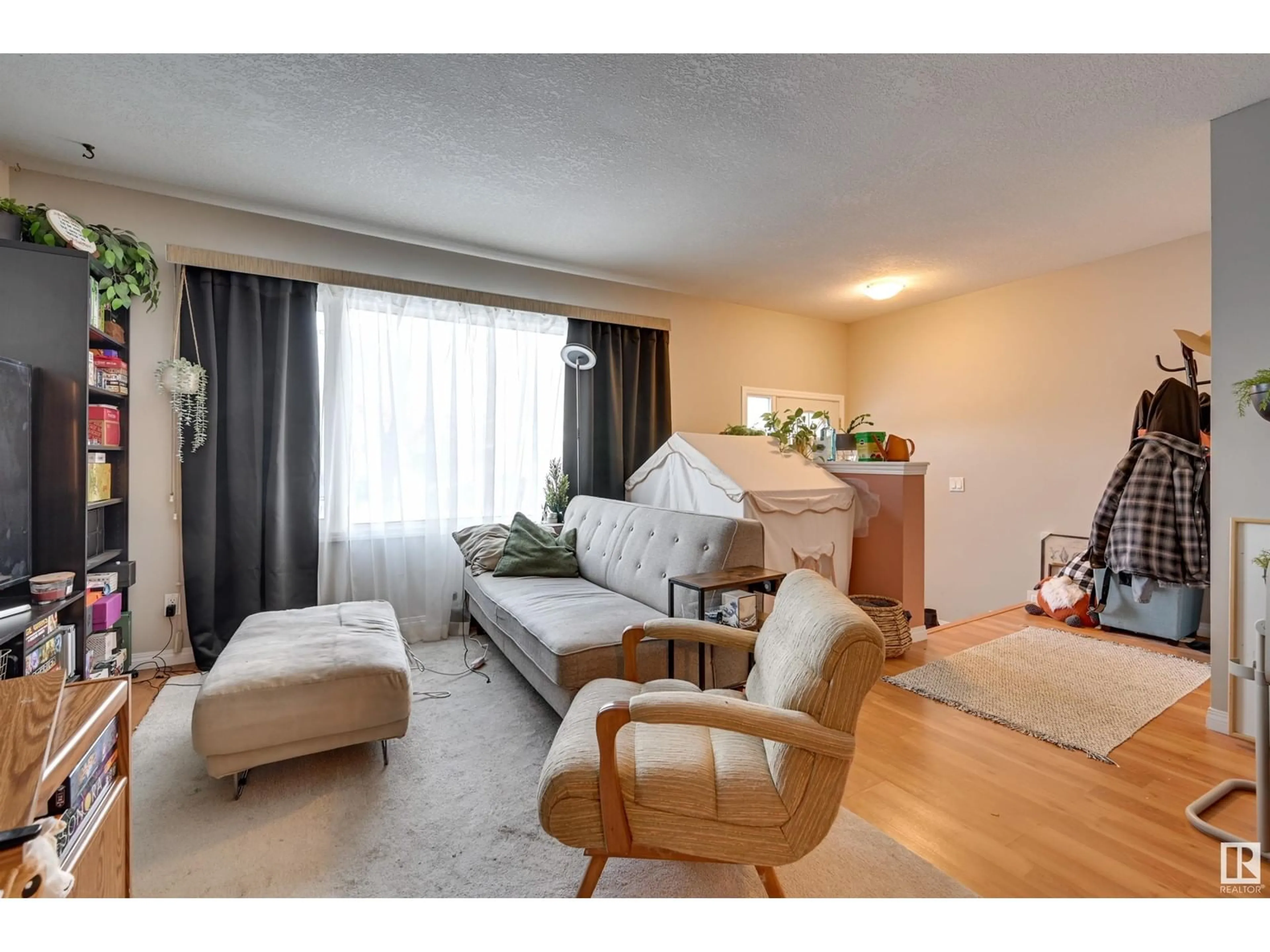 Living room with furniture, wood/laminate floor for 12029 104 ST NW, Edmonton Alberta T5G2L5