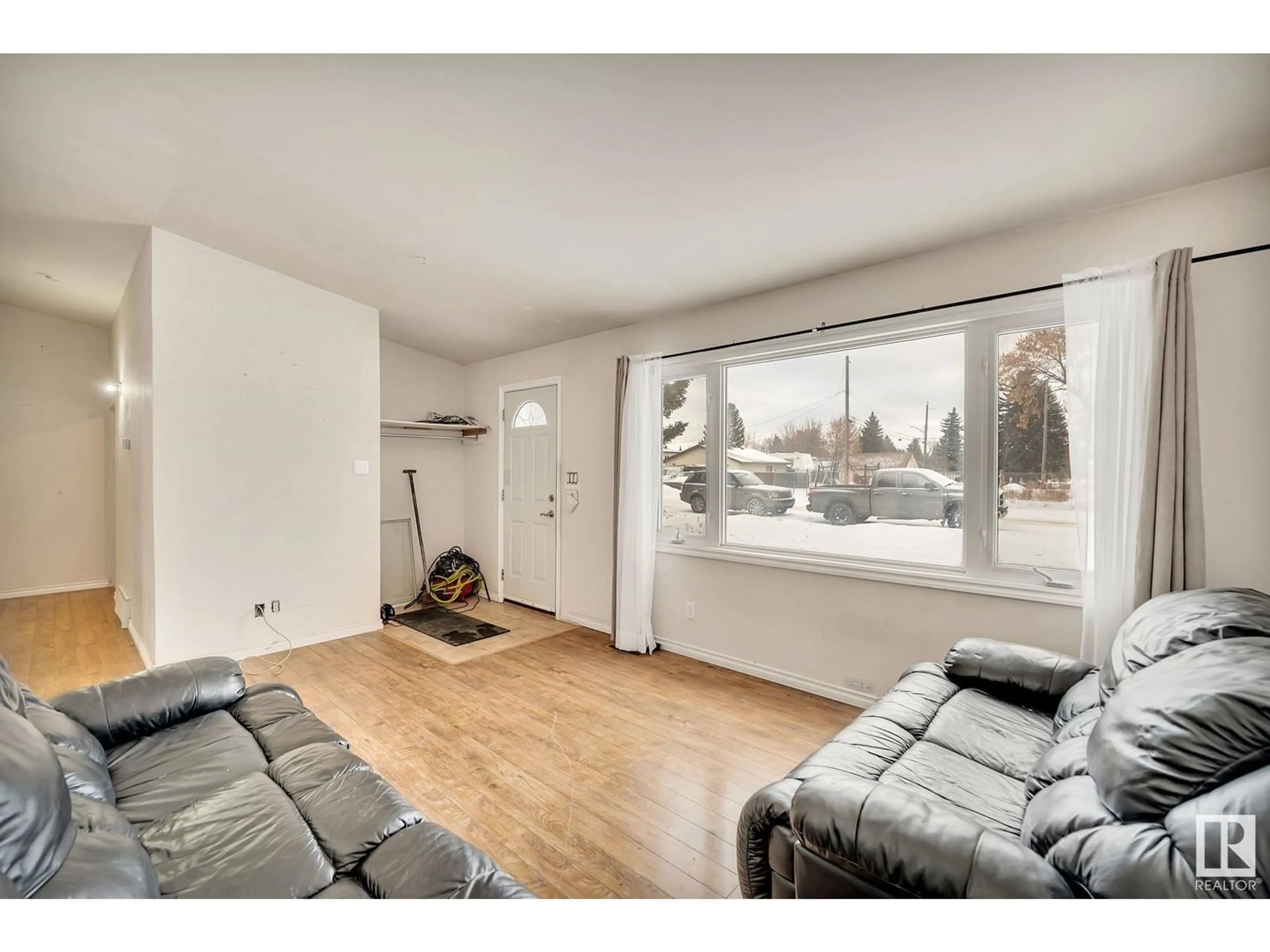 Living room with furniture, wood/laminate floor for 11022 159 ST NW, Edmonton Alberta T5P3C3