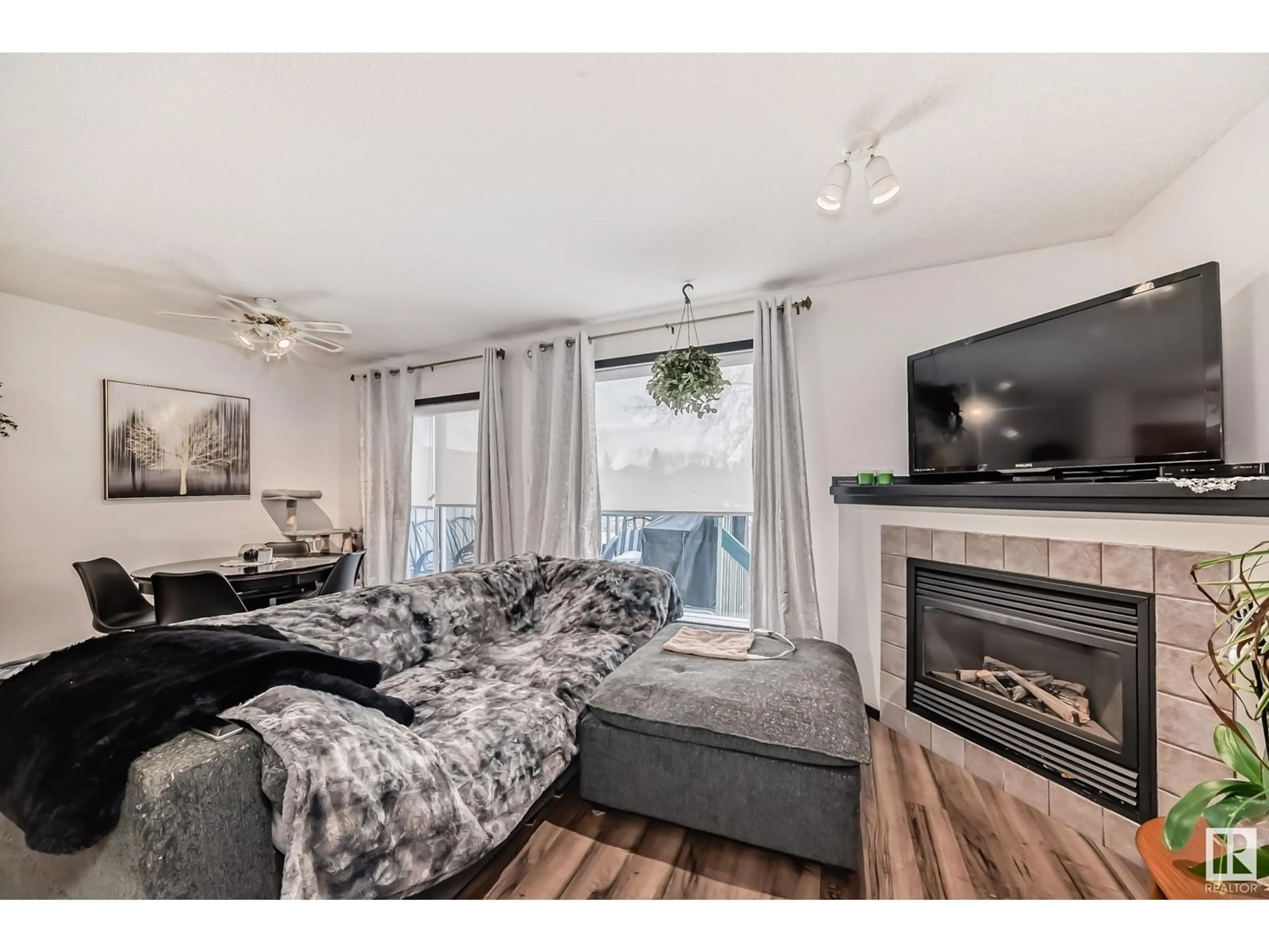 Living room with furniture, wood/laminate floor for #7 14803 Miller BV NW, Edmonton Alberta T5Y3A4