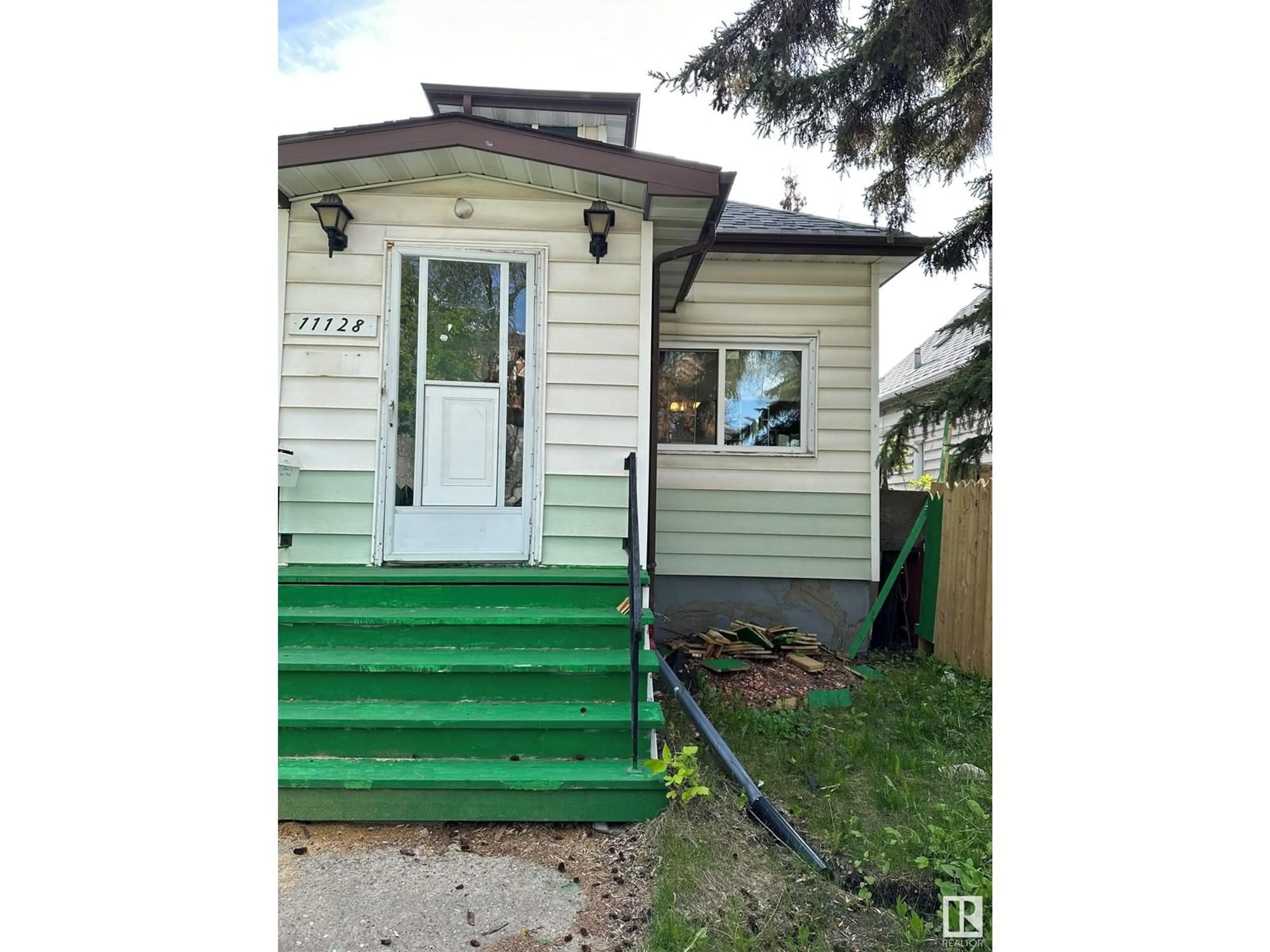 Home with vinyl exterior material, street for 11128 95A ST NW, Edmonton Alberta T5G1N7