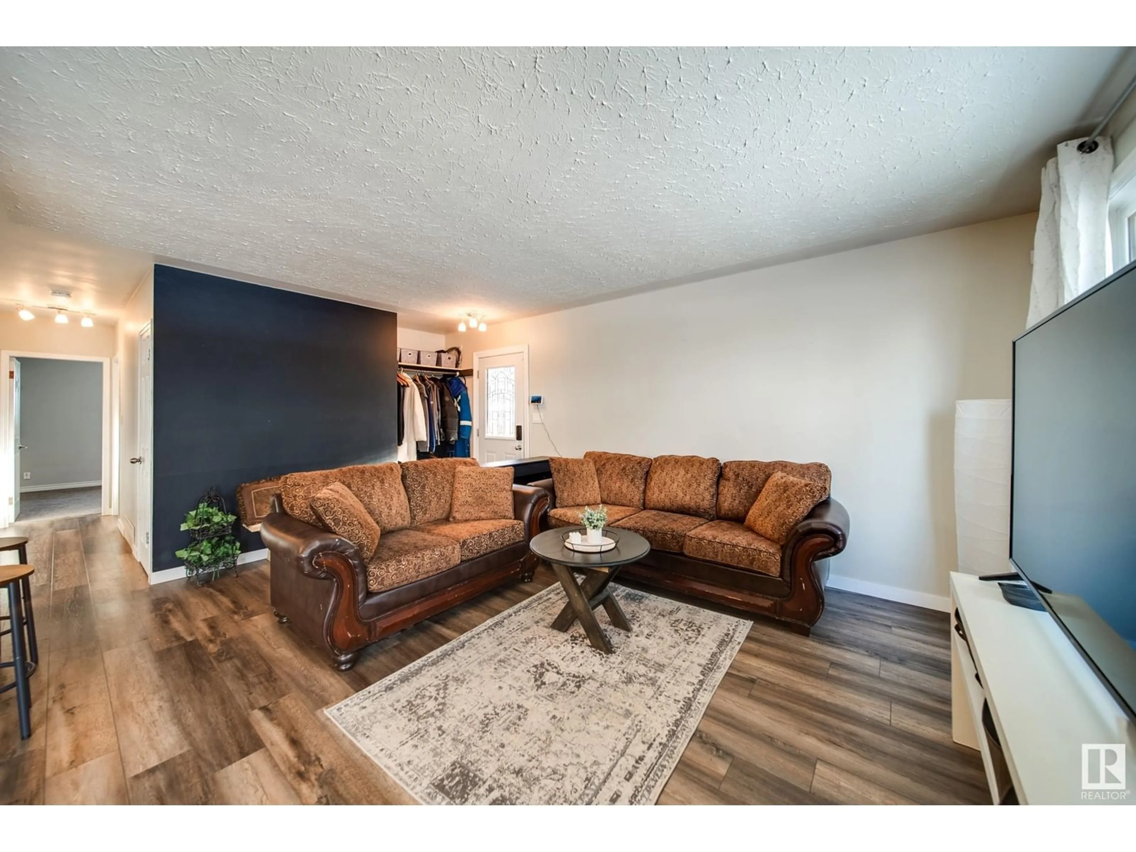 Living room with furniture, wood/laminate floor for 13339 131 ST NW, Edmonton Alberta T5L1N8