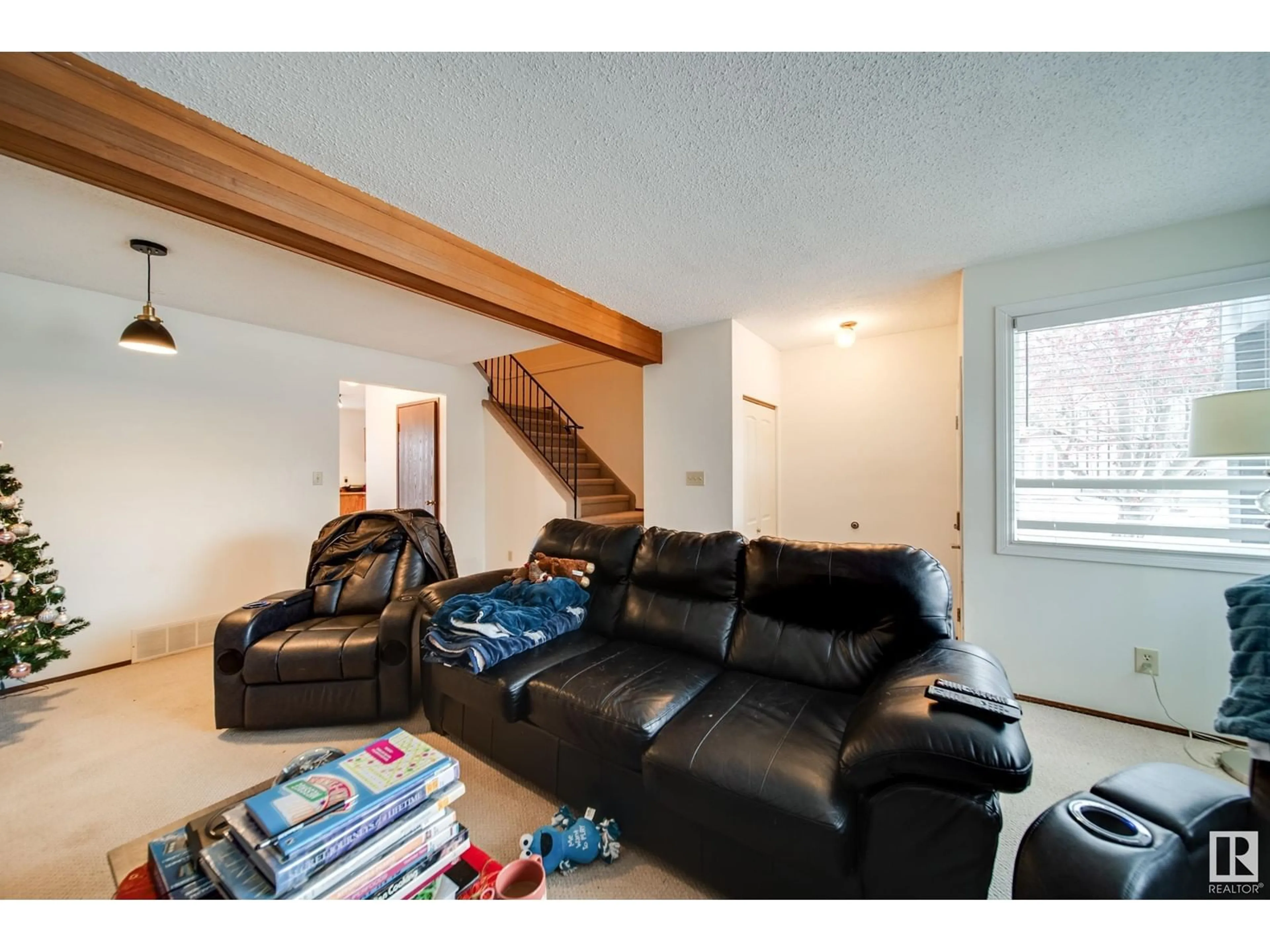 Living room with furniture, wood/laminate floor for 3512 42 AV NW, Edmonton Alberta T6L5C8