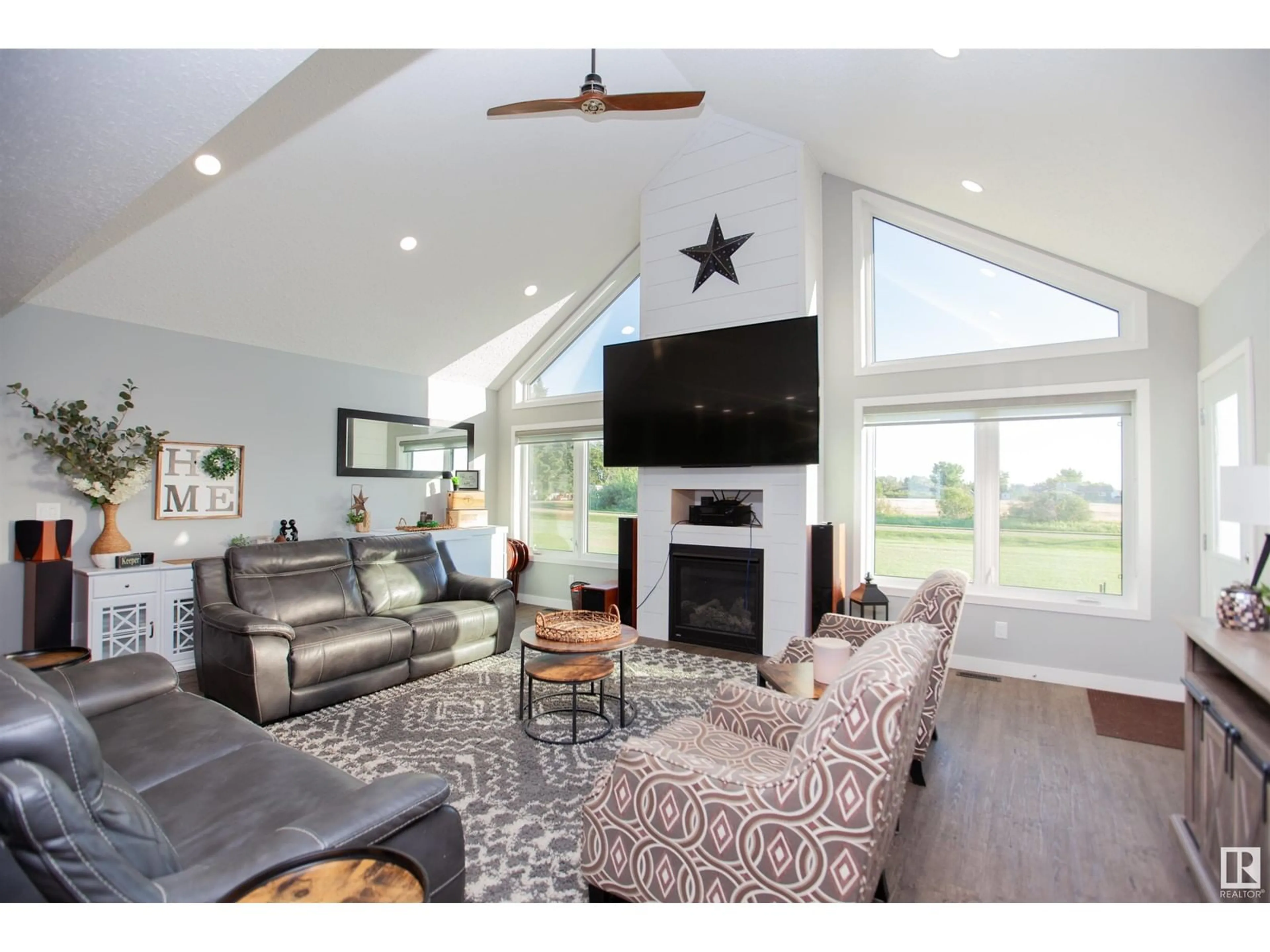 Living room with furniture, wood/laminate floor for 1004 McCarter AV, Rural Camrose County Alberta T0B3P0