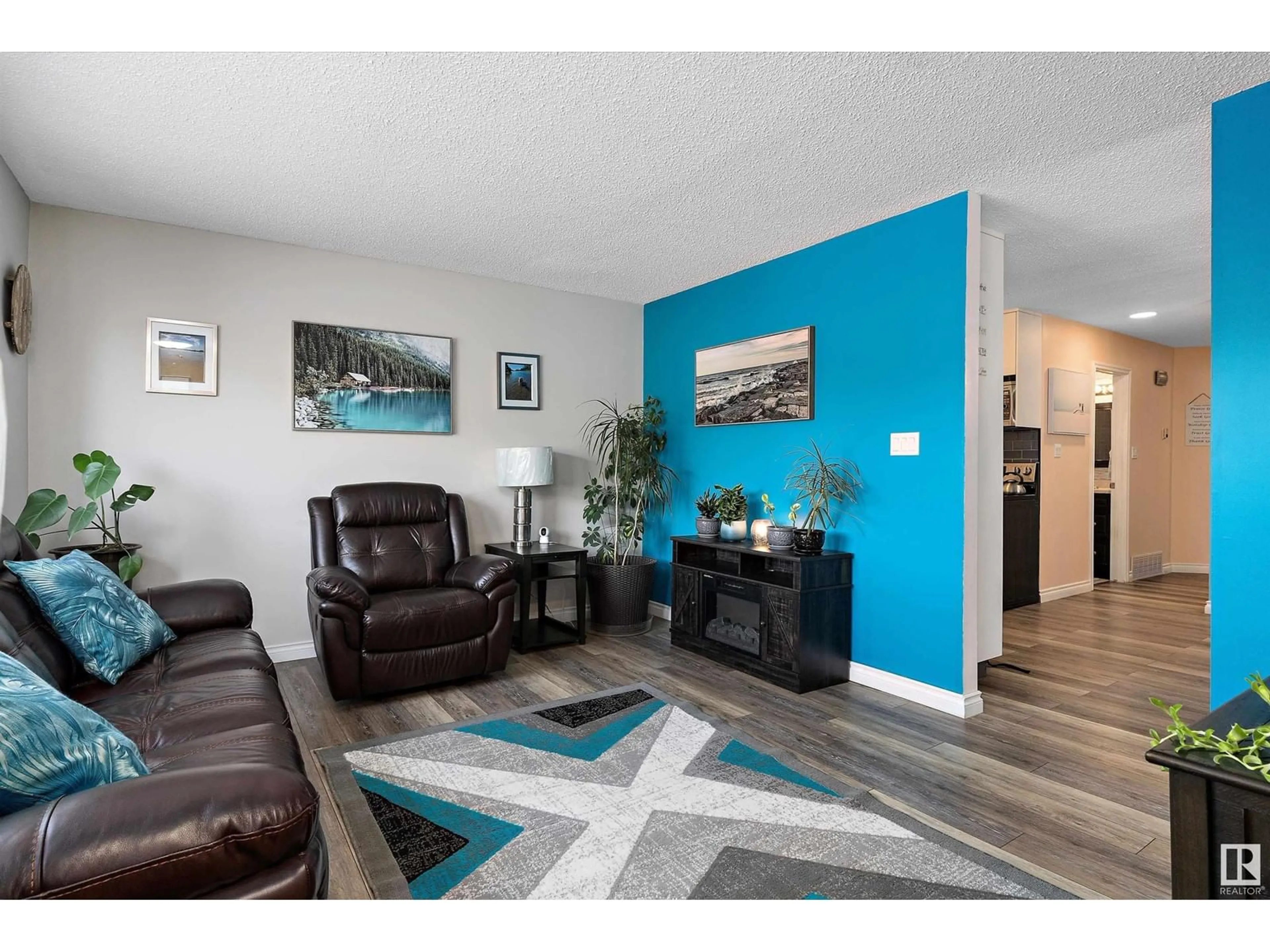 Living room with furniture, wood/laminate floor for 4653 126 AV NW, Edmonton Alberta T5A4L1