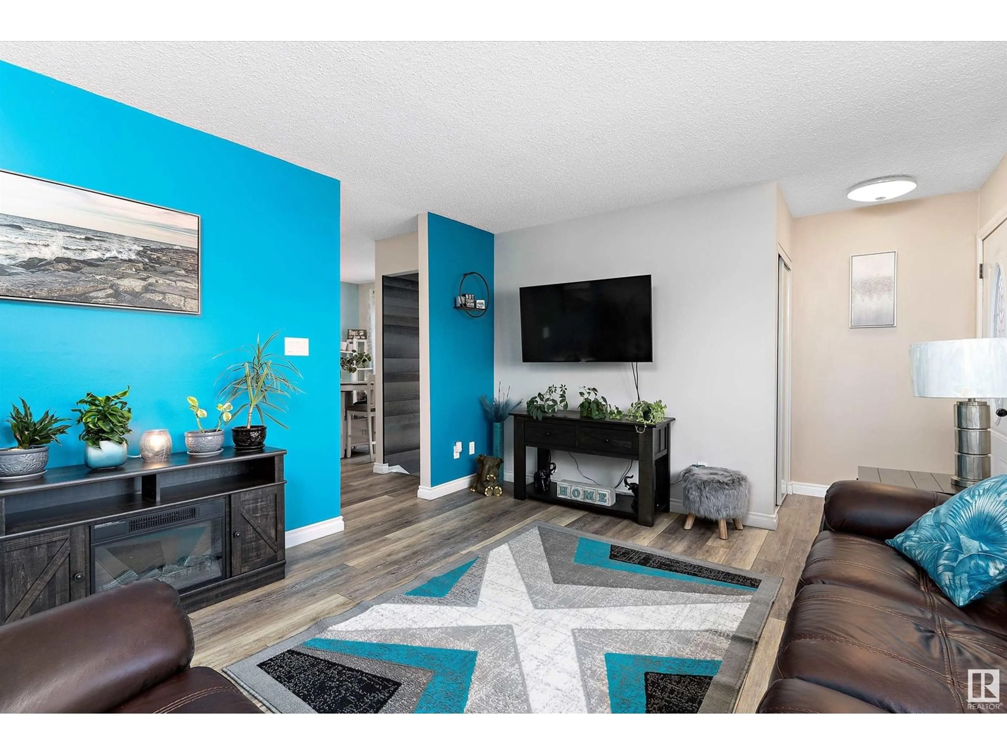 Living room with furniture, wood/laminate floor for 4653 126 AV NW, Edmonton Alberta T5A4L1