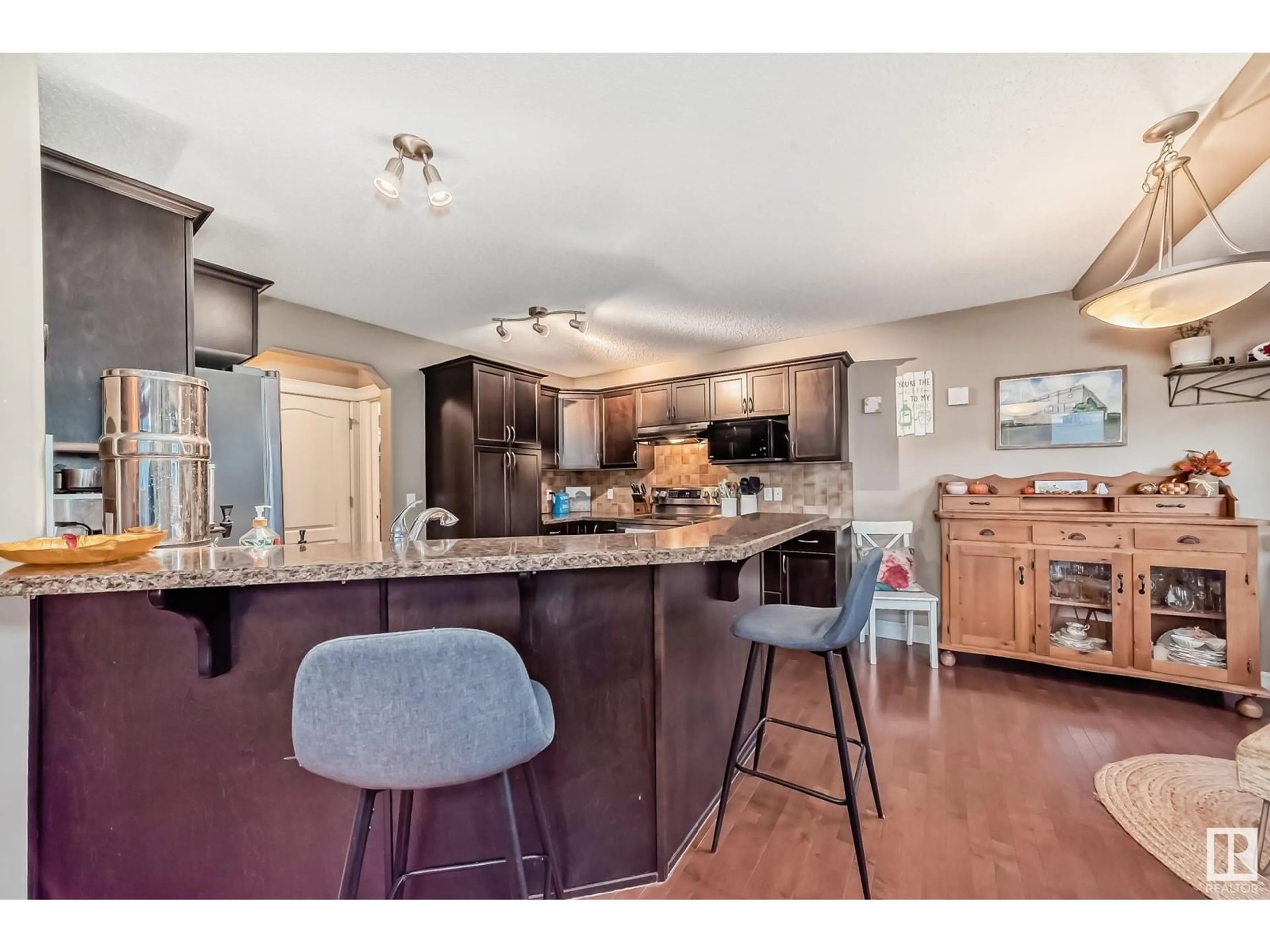 Open concept kitchen, wood/laminate floor for 25 Cranberry BN, Fort Saskatchewan Alberta T8L0H2