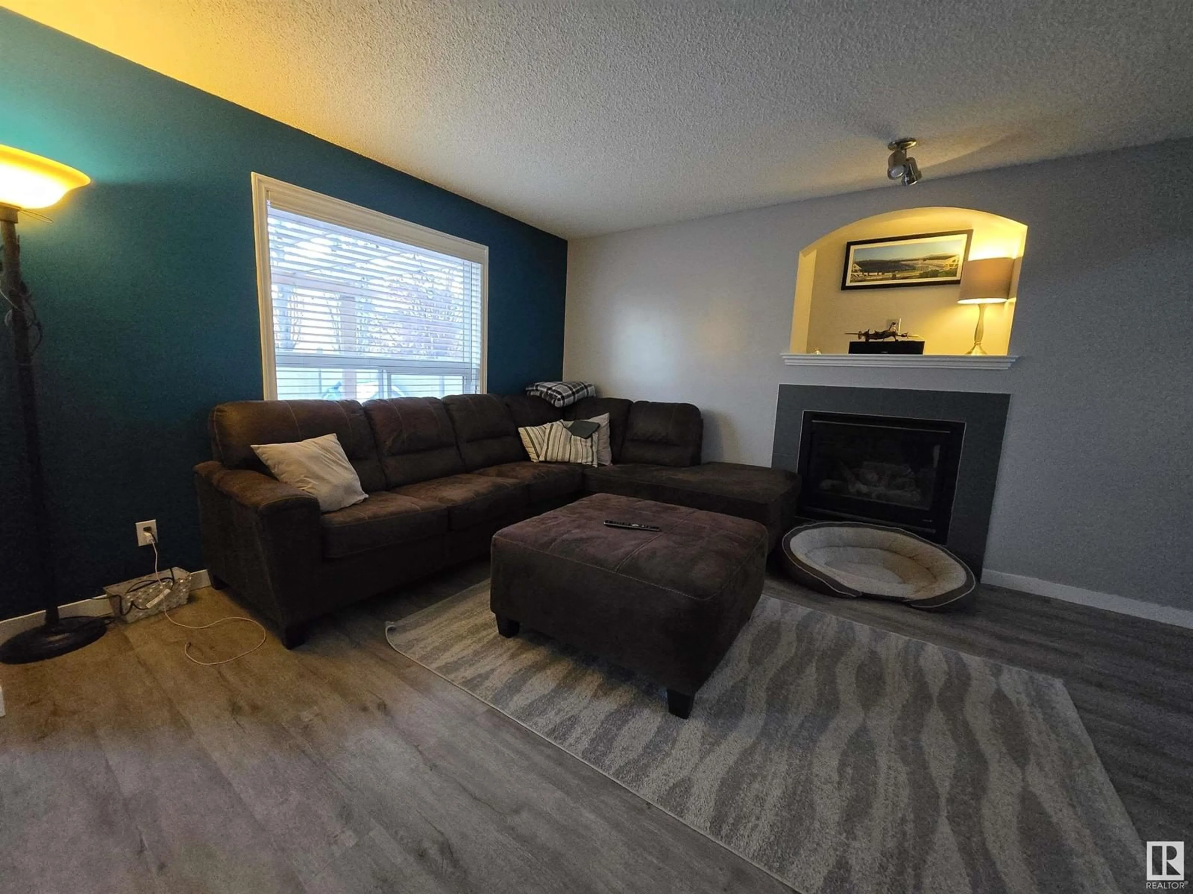 Living room with furniture, wood/laminate floor for 24 LAWSON BV, Spruce Grove Alberta T7X4P1