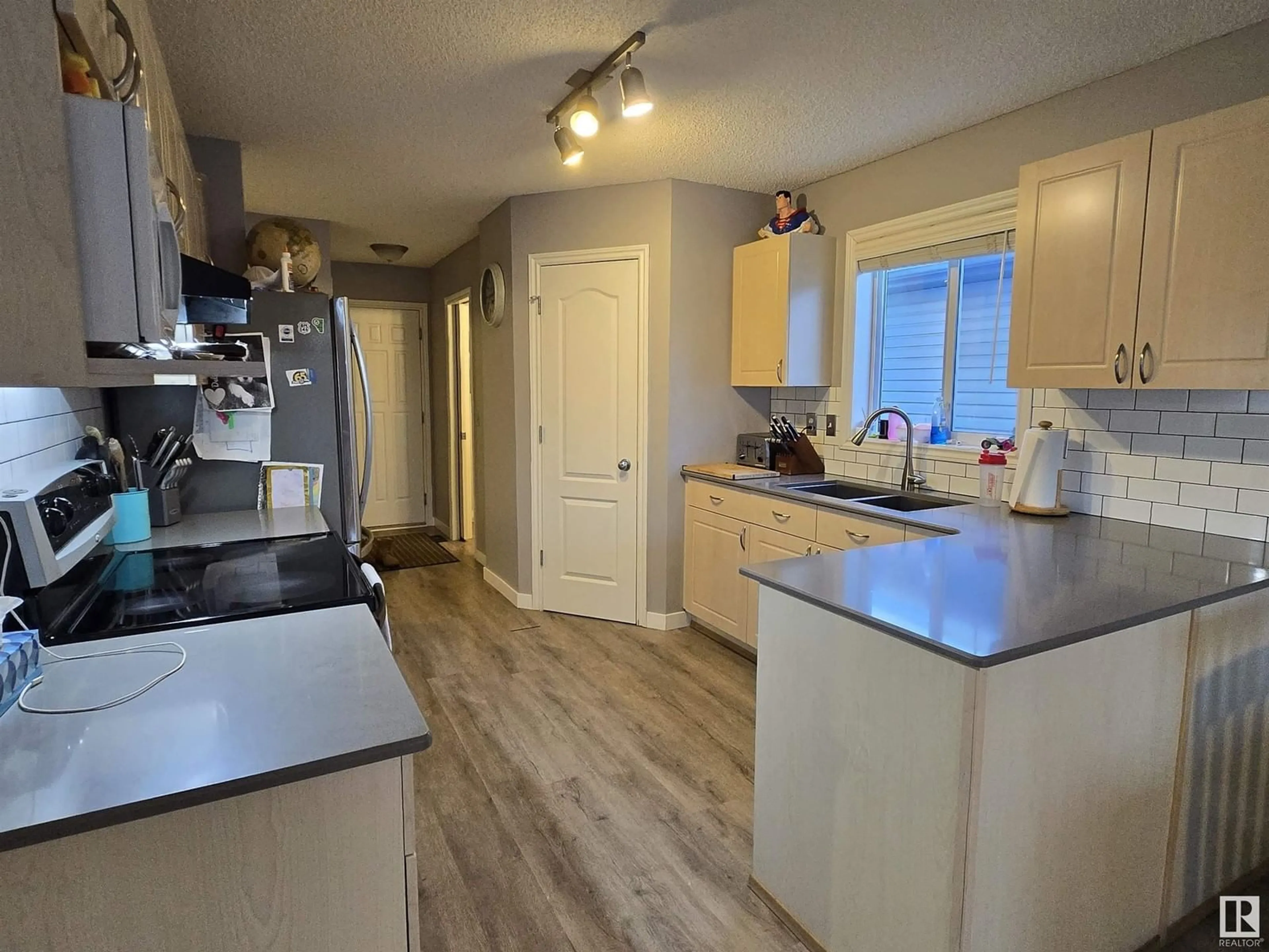 Open concept kitchen, wood/laminate floor for 24 LAWSON BV, Spruce Grove Alberta T7X4P1