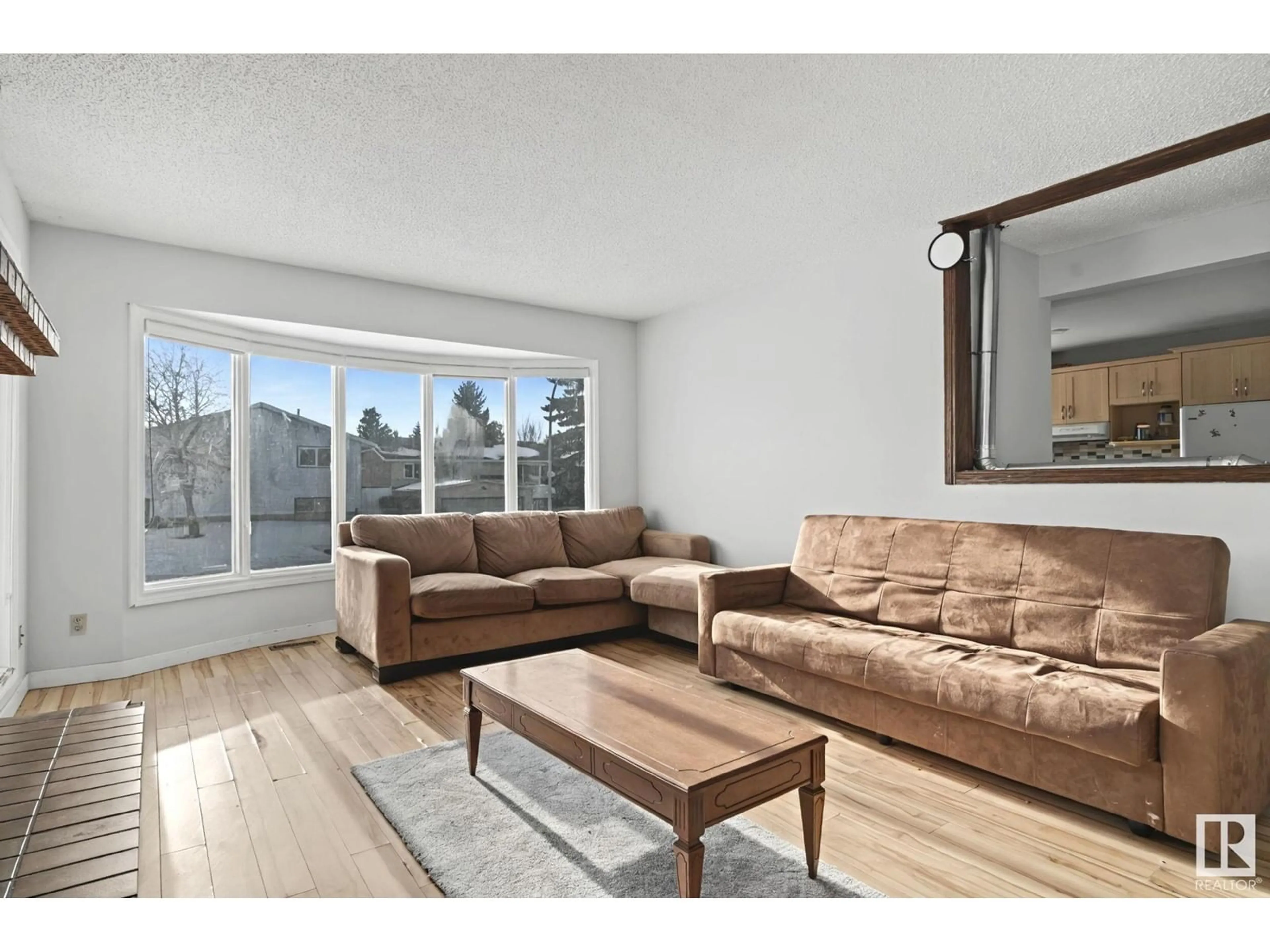 Living room with furniture, wood/laminate floor for 3004 42 ST NW NW, Edmonton Alberta T6L4P2