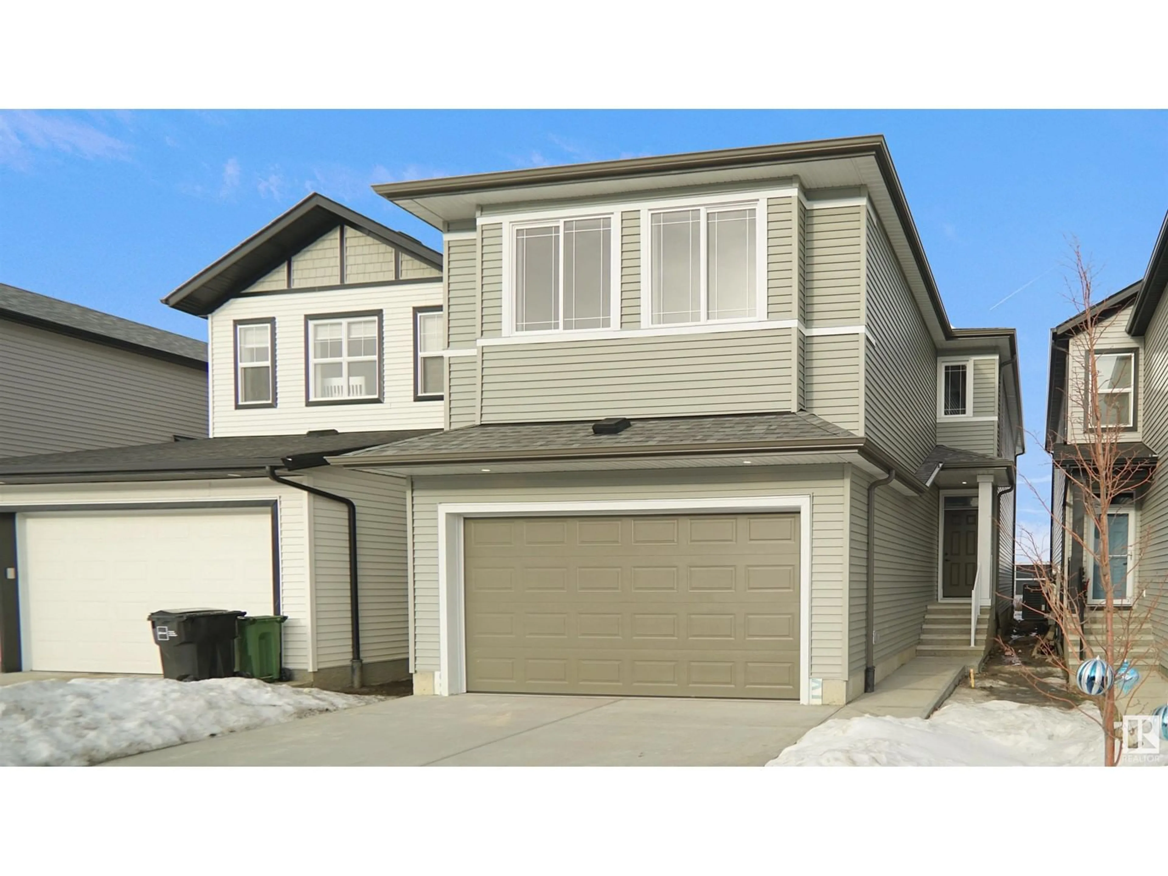 Home with vinyl exterior material, street for 2832 152 AV NW, Edmonton Alberta T5Y6C4