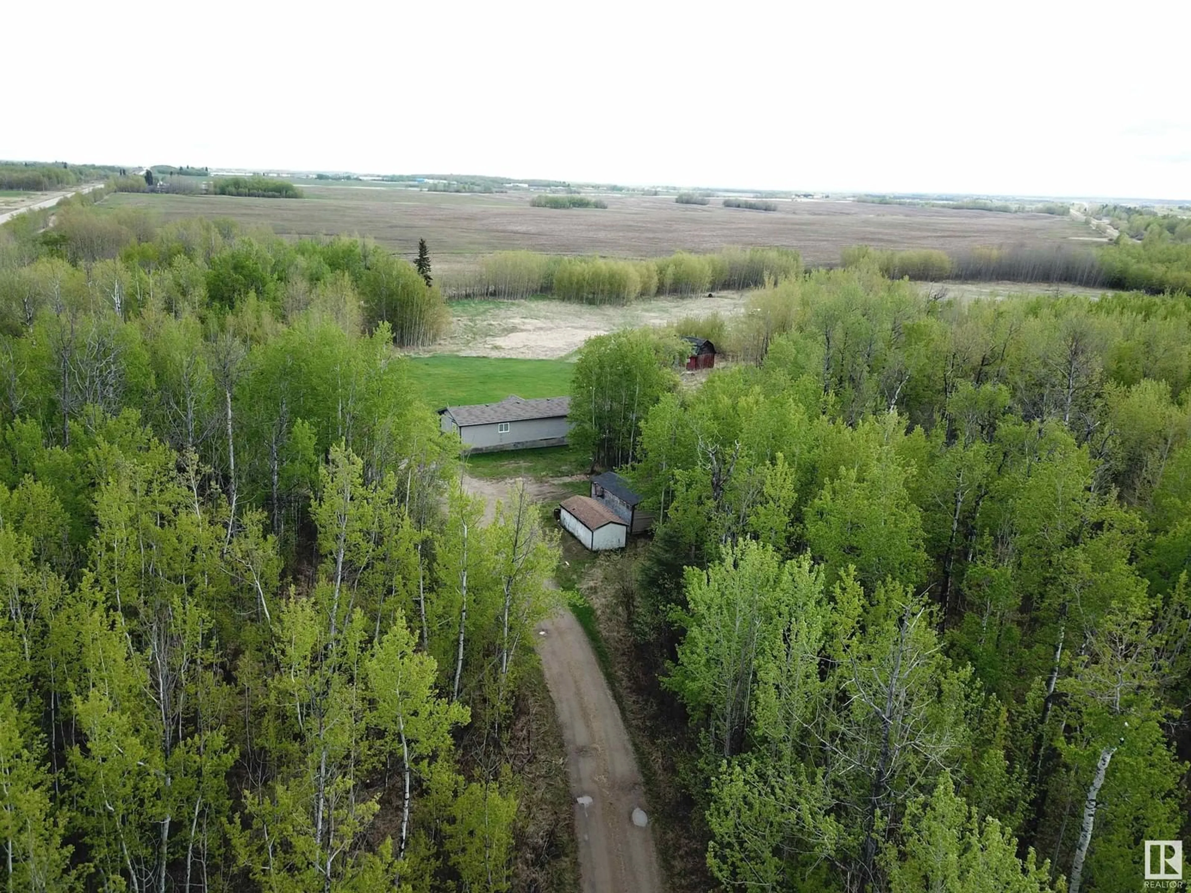 A pic from outside/outdoor area/front of a property/back of a property/a pic from drone, forest/trees view for 9119 HWY 18, Rural Lac Ste. Anne County Alberta T0E0J0