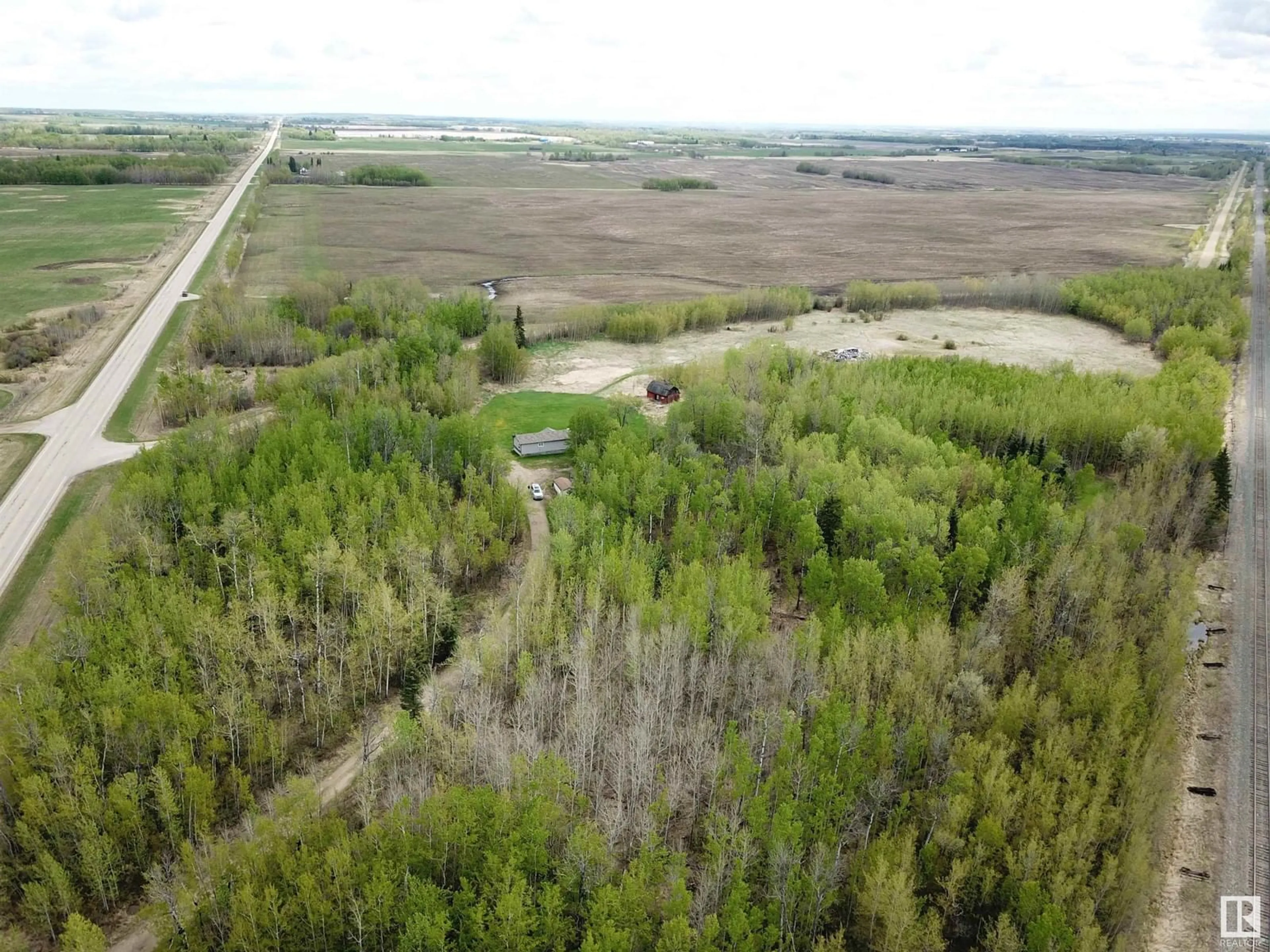 A pic from outside/outdoor area/front of a property/back of a property/a pic from drone, forest/trees view for 9119 HWY 18, Rural Lac Ste. Anne County Alberta T0E0J0