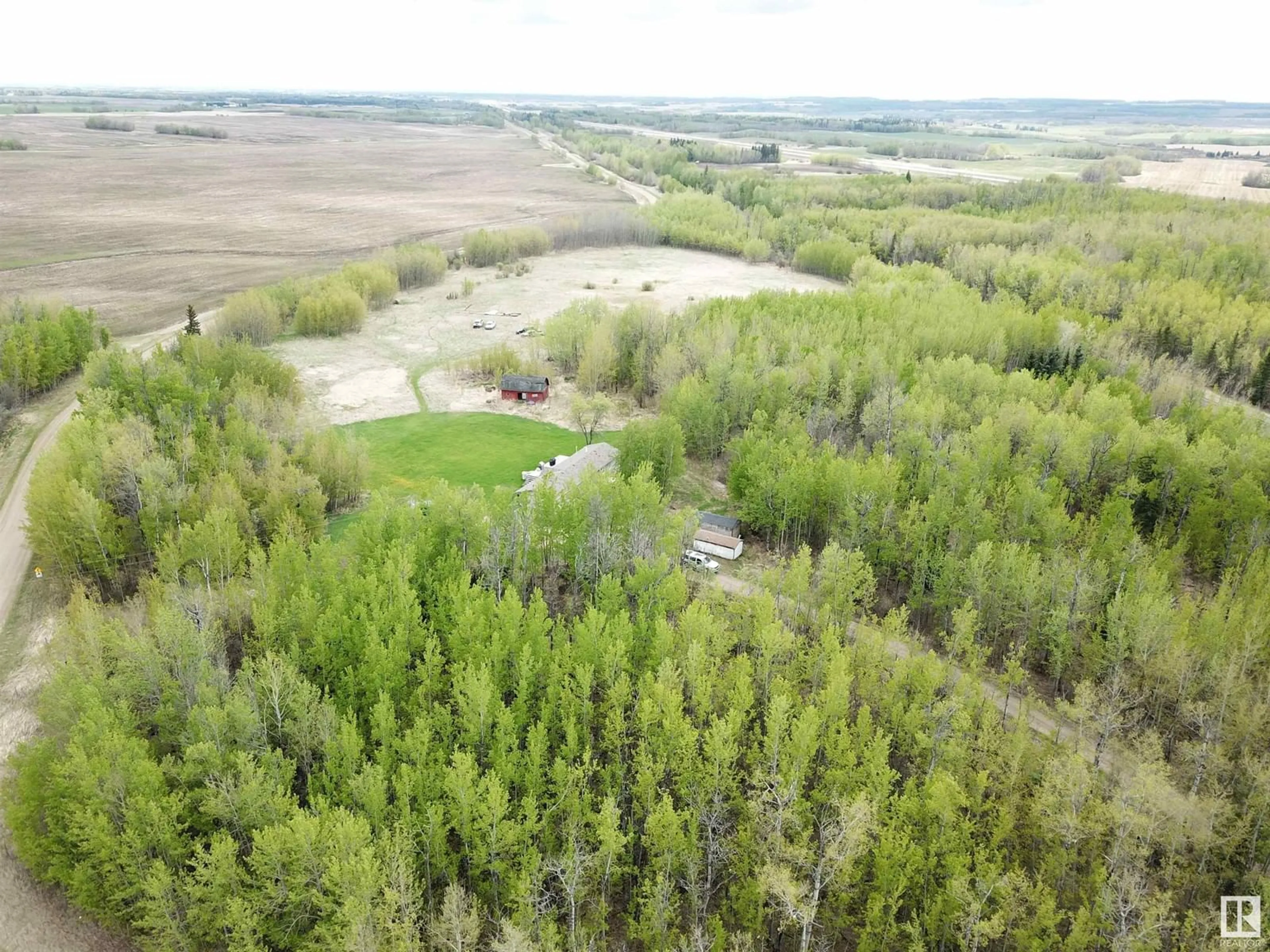 A pic from outside/outdoor area/front of a property/back of a property/a pic from drone, forest/trees view for 9119 HWY 18, Rural Lac Ste. Anne County Alberta T0E0J0