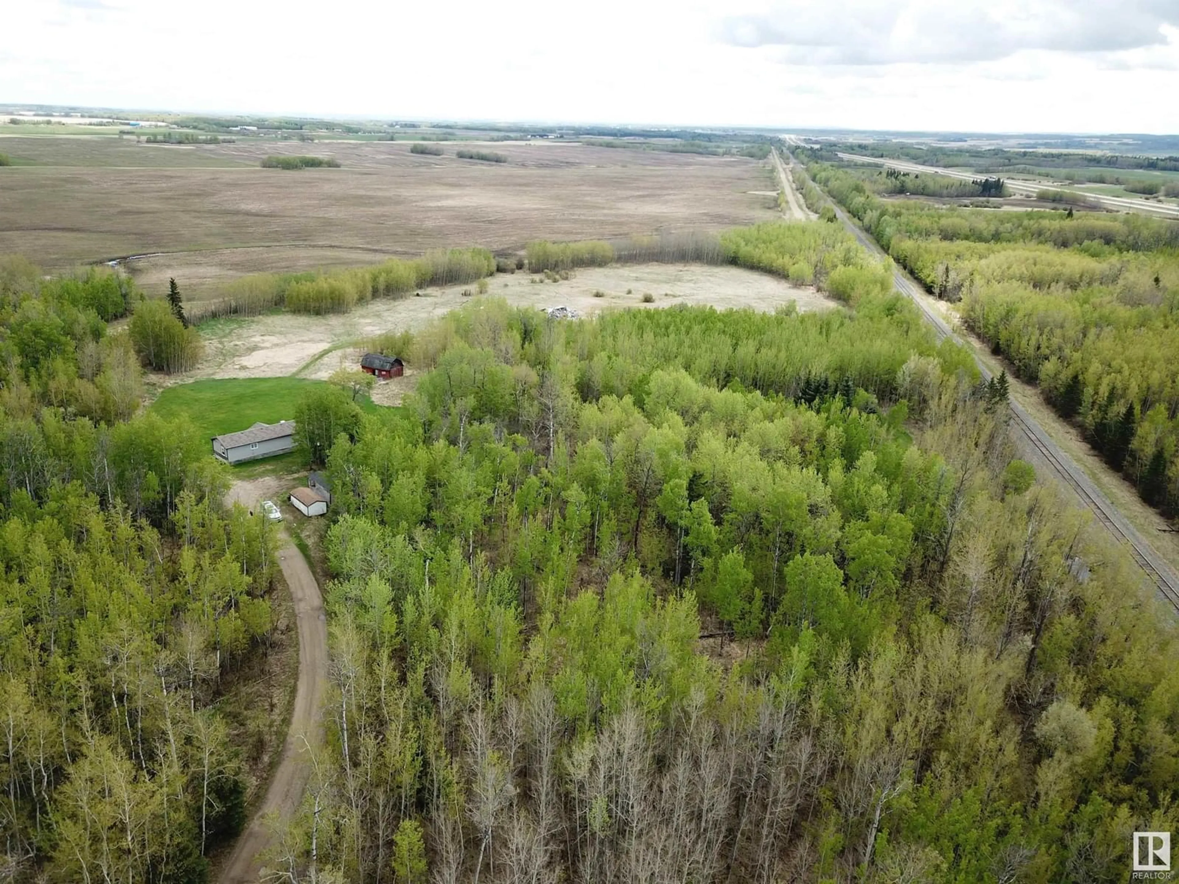 A pic from outside/outdoor area/front of a property/back of a property/a pic from drone, forest/trees view for 9119 HWY 18, Rural Lac Ste. Anne County Alberta T0E0J0