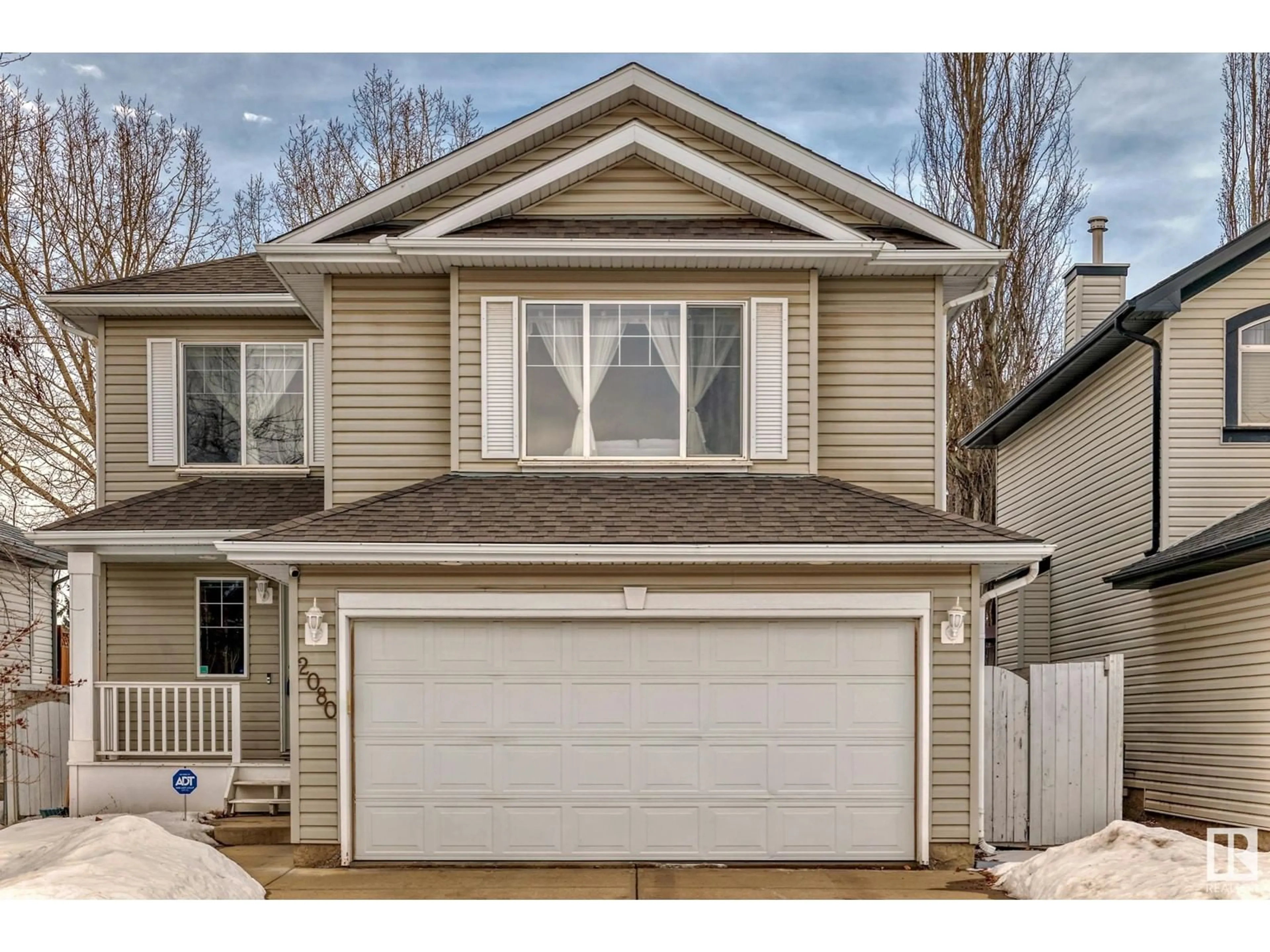 Home with vinyl exterior material, street for 2080 Brennan CR NW NW, Edmonton Alberta T5T6M3