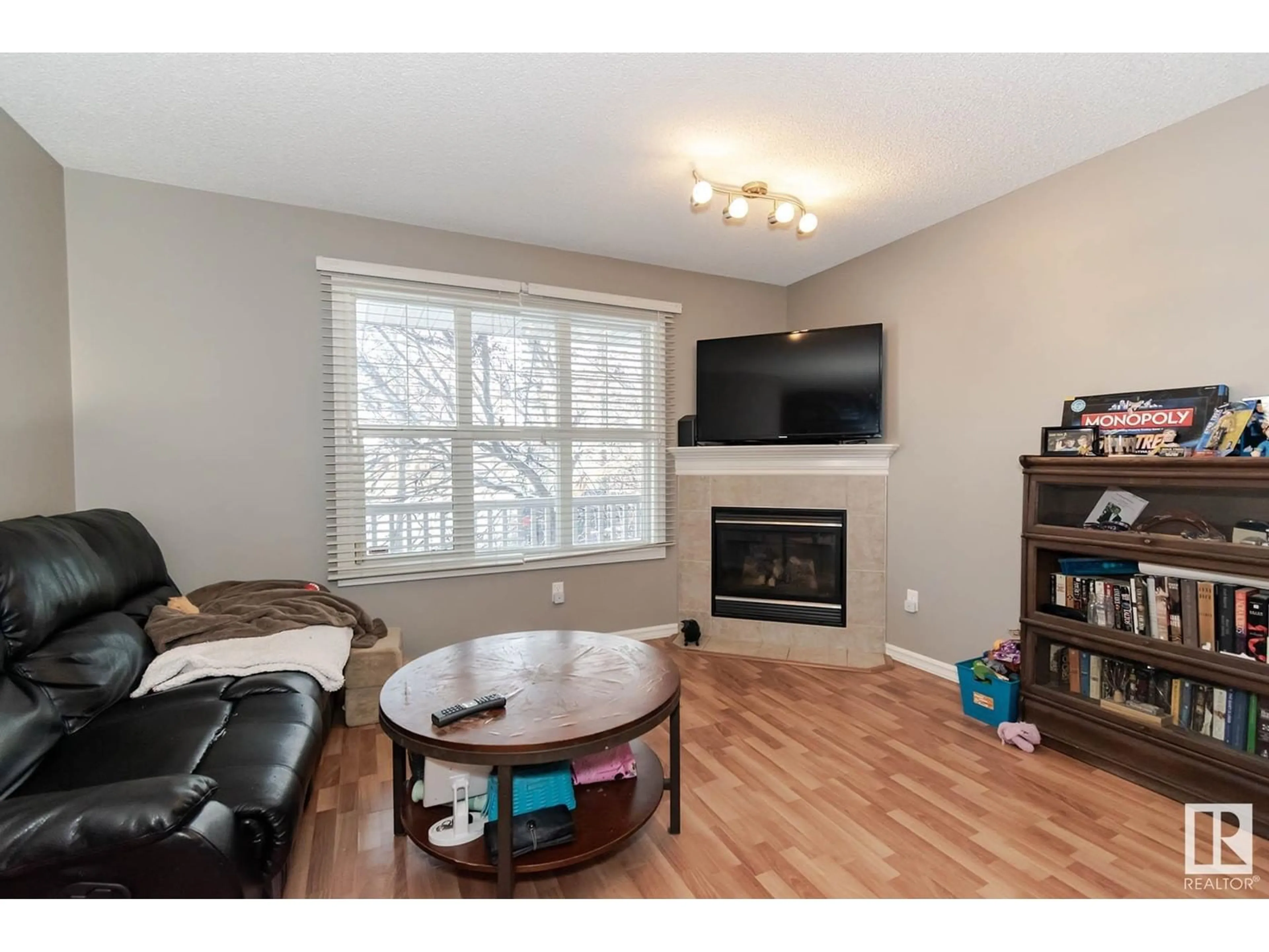 Living room with furniture, wood/laminate floor for 21223 91 AV NW, Edmonton Alberta T5T0W4