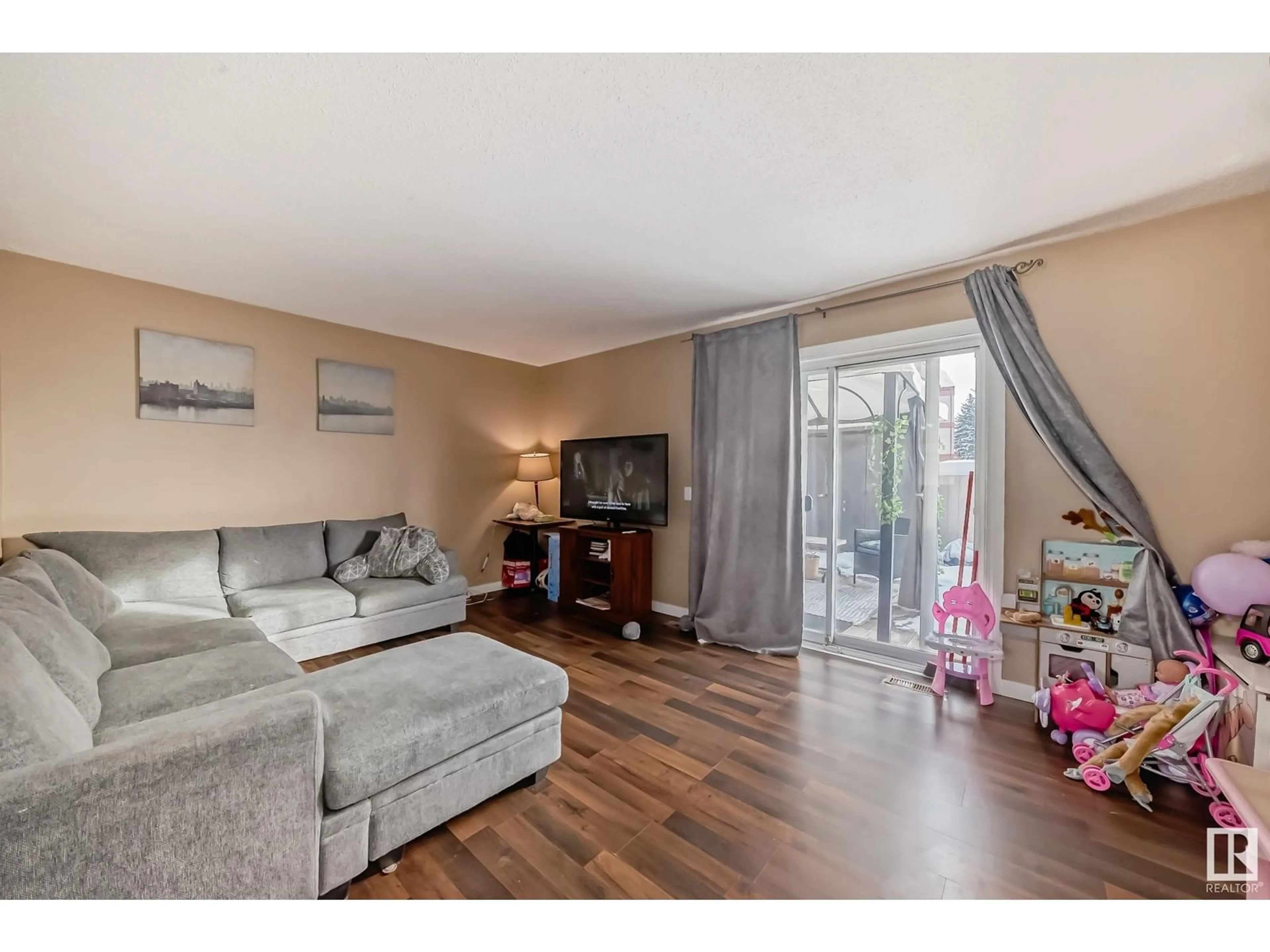 Living room with furniture, wood/laminate floor for 117 WOODBOROUGH WY NW, Edmonton Alberta T5Y1N2