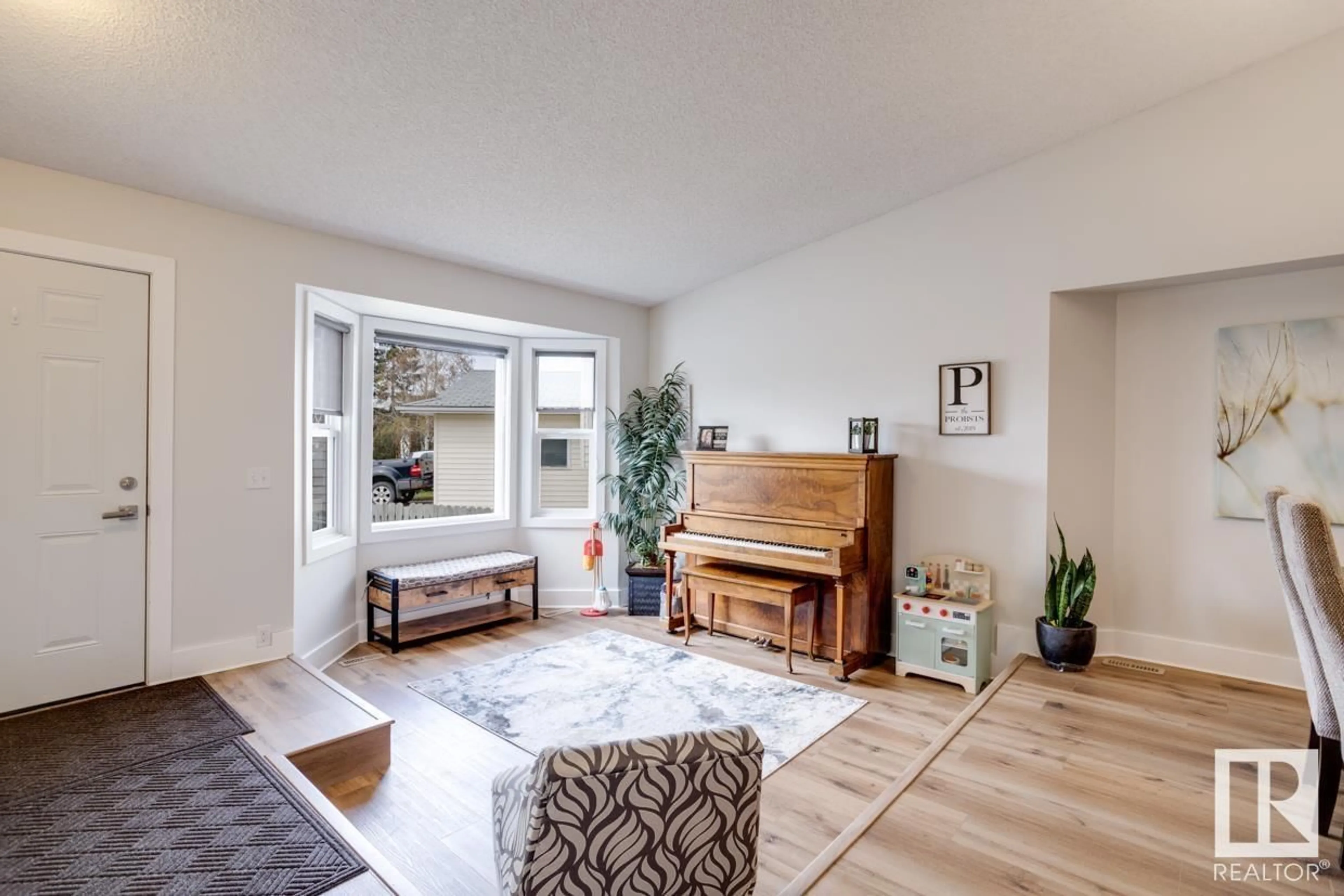 Living room with furniture, wood/laminate floor for 3903 34A AV NW, Edmonton Alberta T6L3Z3