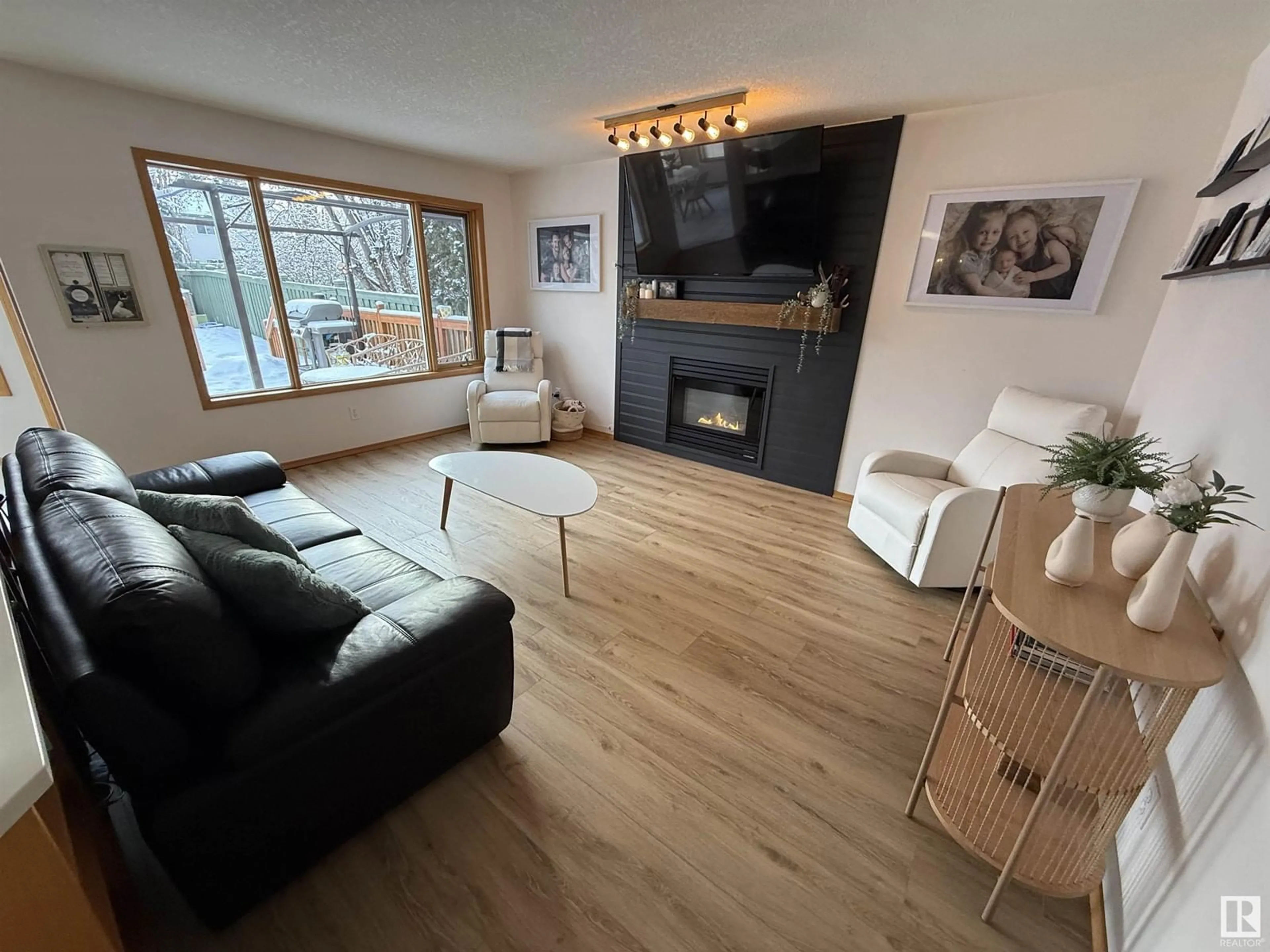 Living room with furniture, wood/laminate floor for 1507 WELLWOOD WY NW, Edmonton Alberta T6M2M3