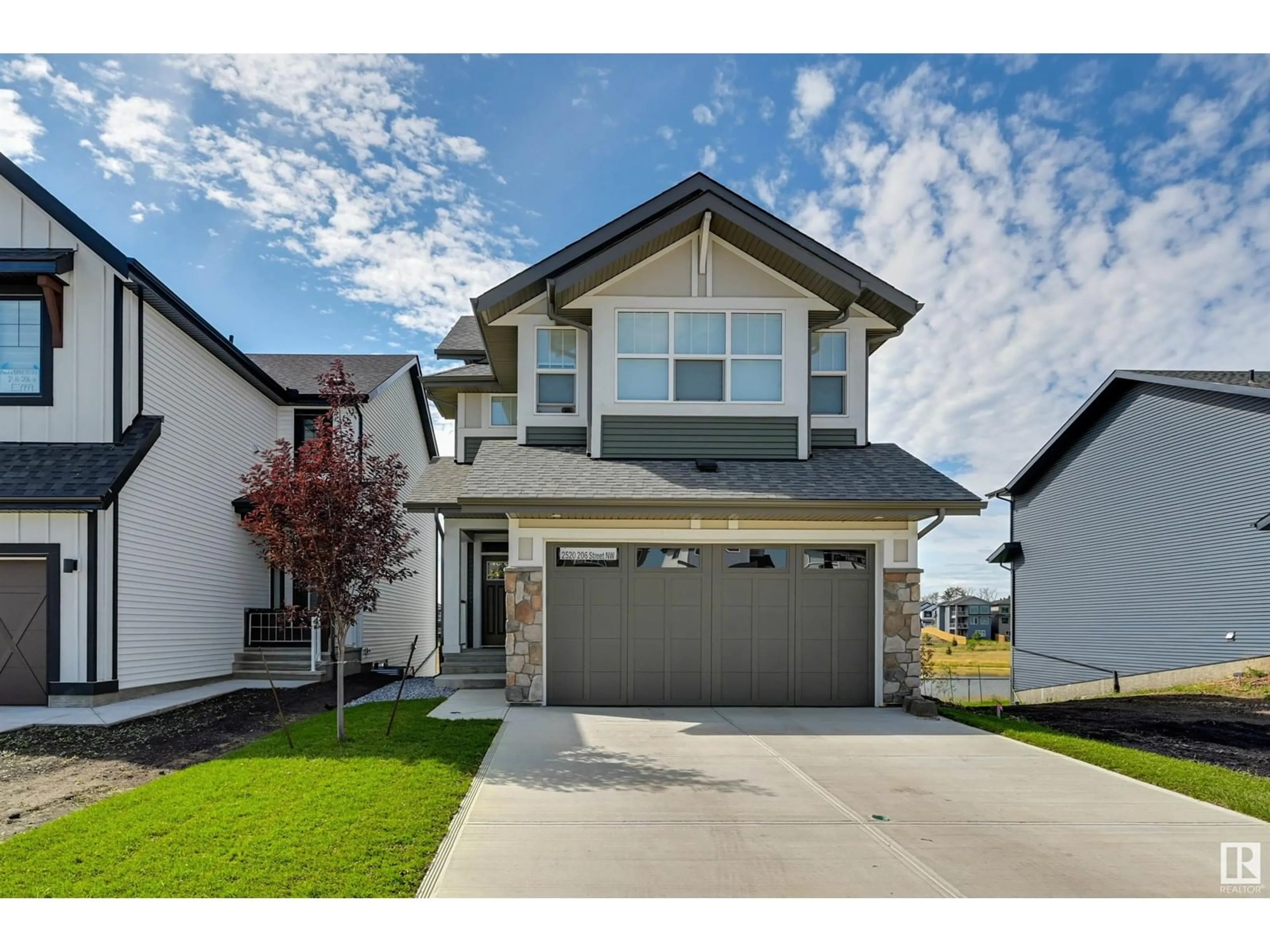 Home with vinyl exterior material, street for 2520 206 ST, Edmonton Alberta T6M1P1