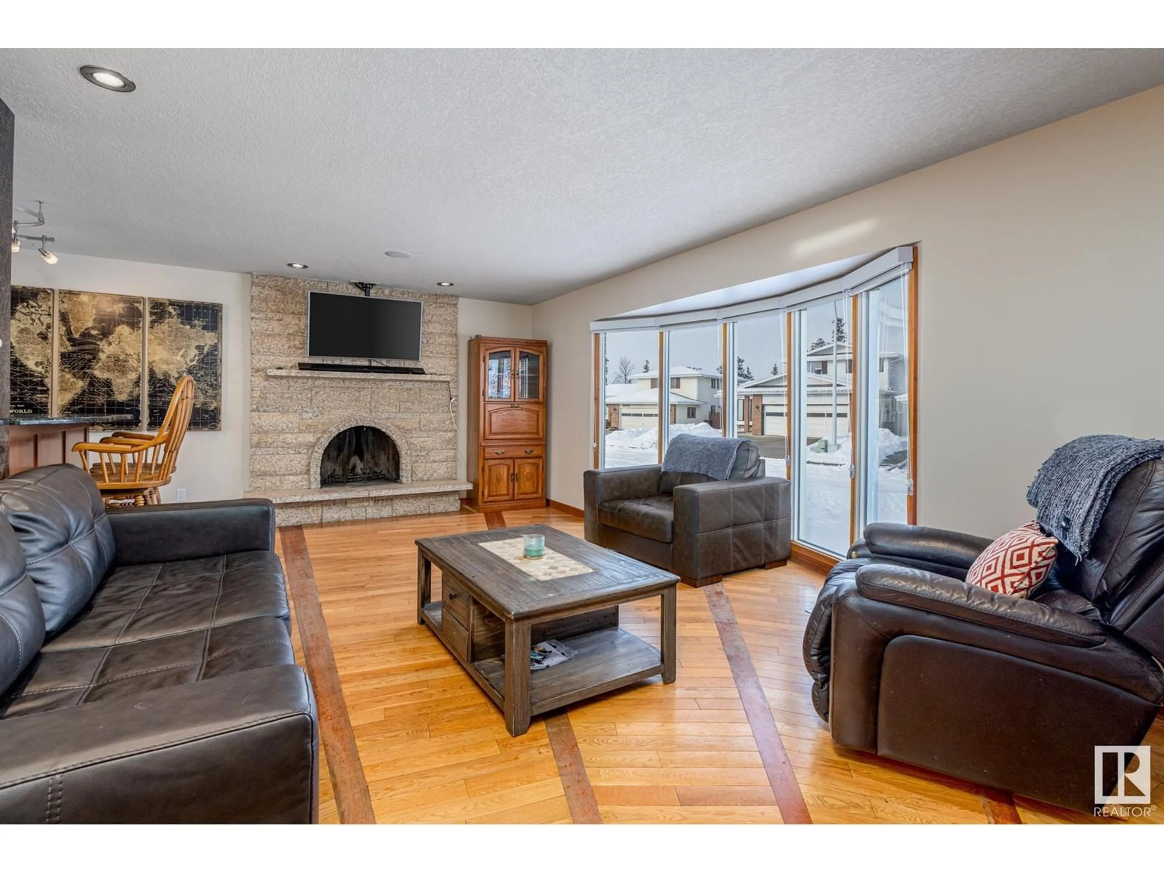 Living room with furniture, wood/laminate floor for 6960 21 AV NW, Edmonton Alberta T6K2H4